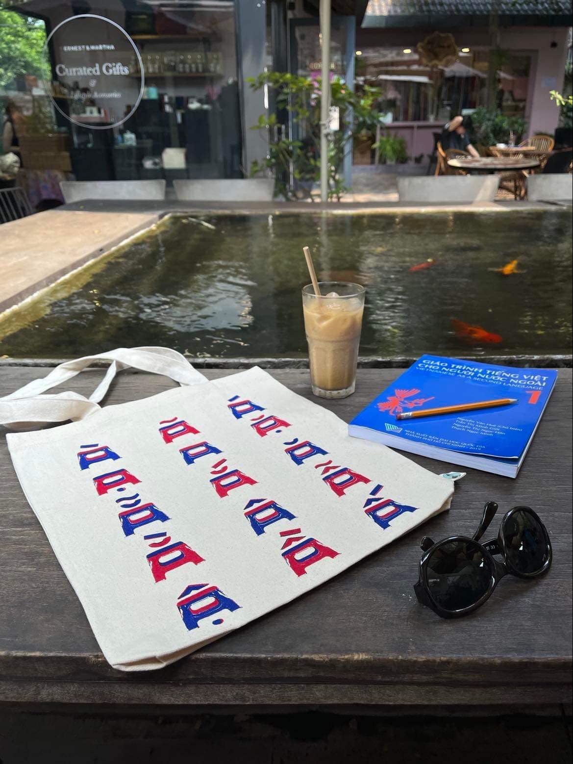 A Streetside Alphabet Kitchen Towel - styled presentation in white by Bat-trang