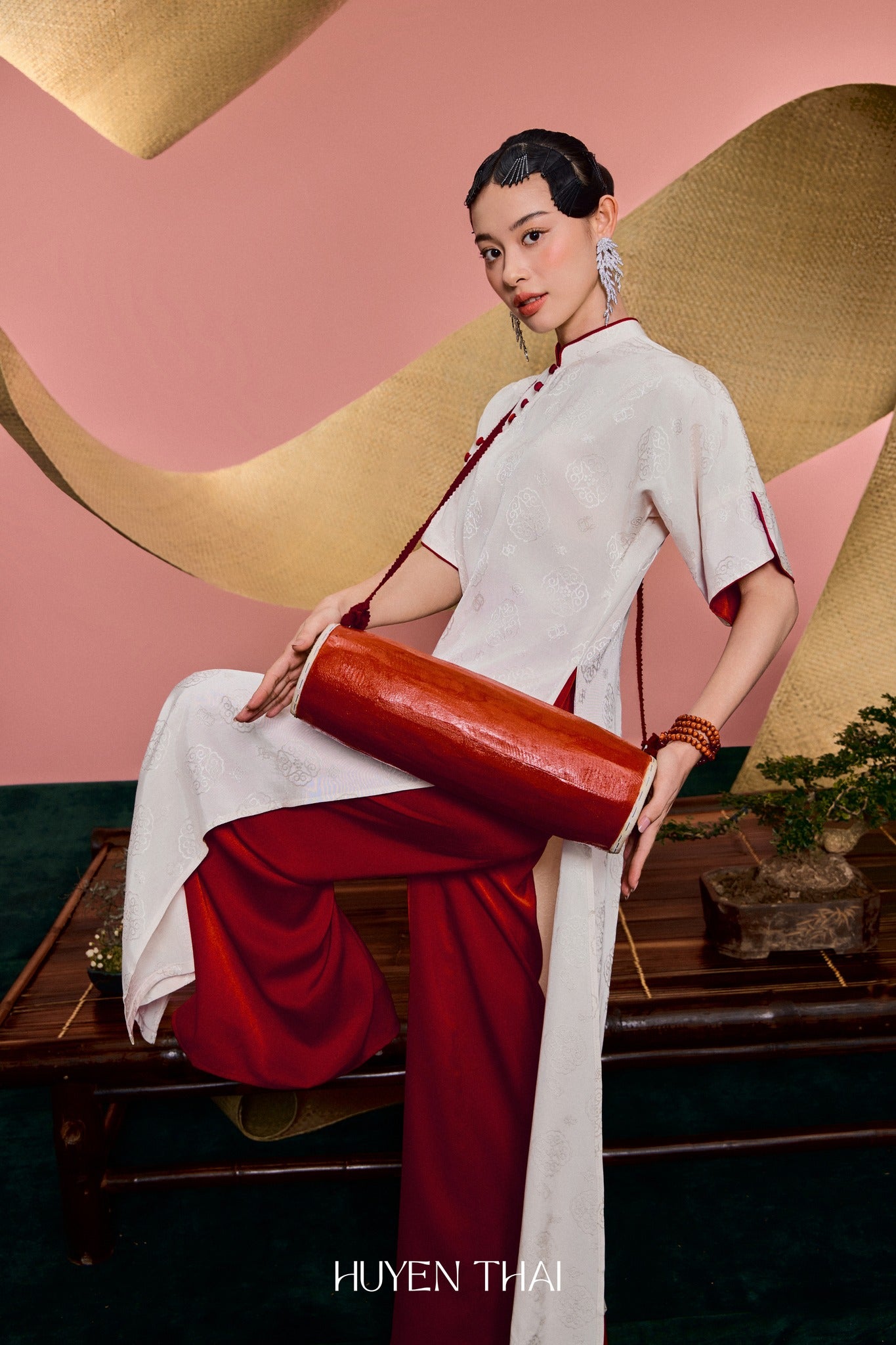 "Van Nha Ao Dai in ivory silk with crimson lining, traditional Vietnamese dress by Huyen Collection."