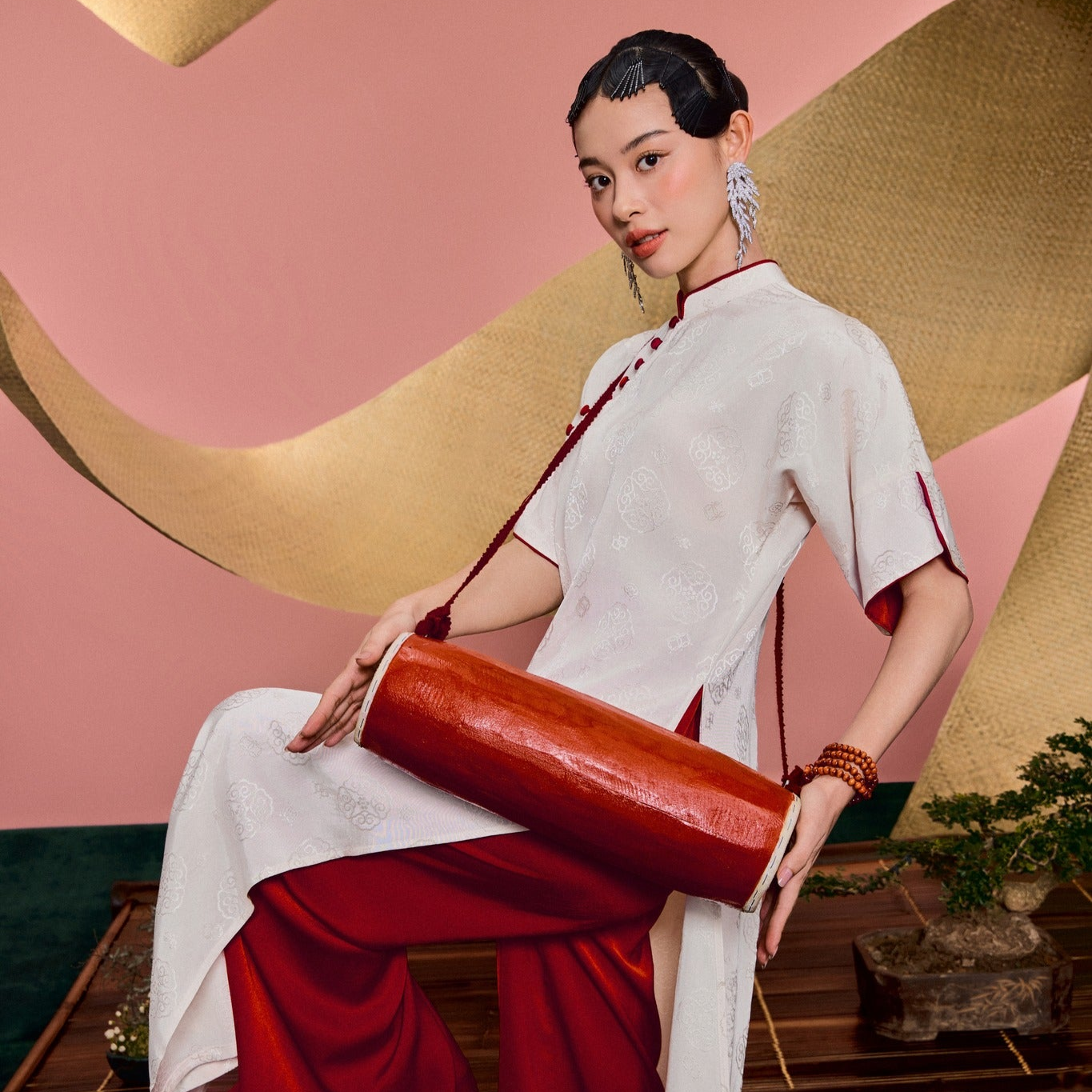 "Van Nha Ao Dai in ivory silk with crimson lining, traditional Vietnamese dress by Huyen Collection."