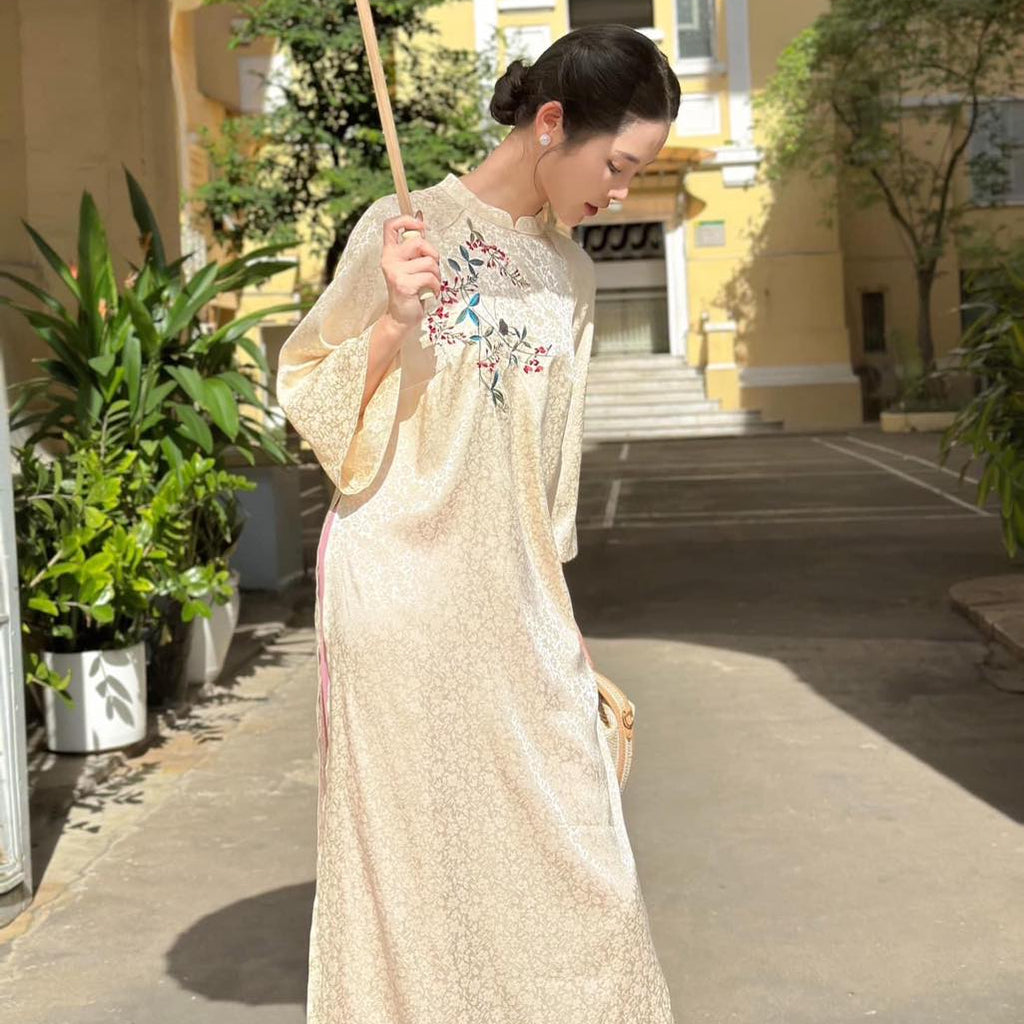 Traditional Vietnamese Ao Dai "Ho Diep" in cream silk, back view with contrasting pants