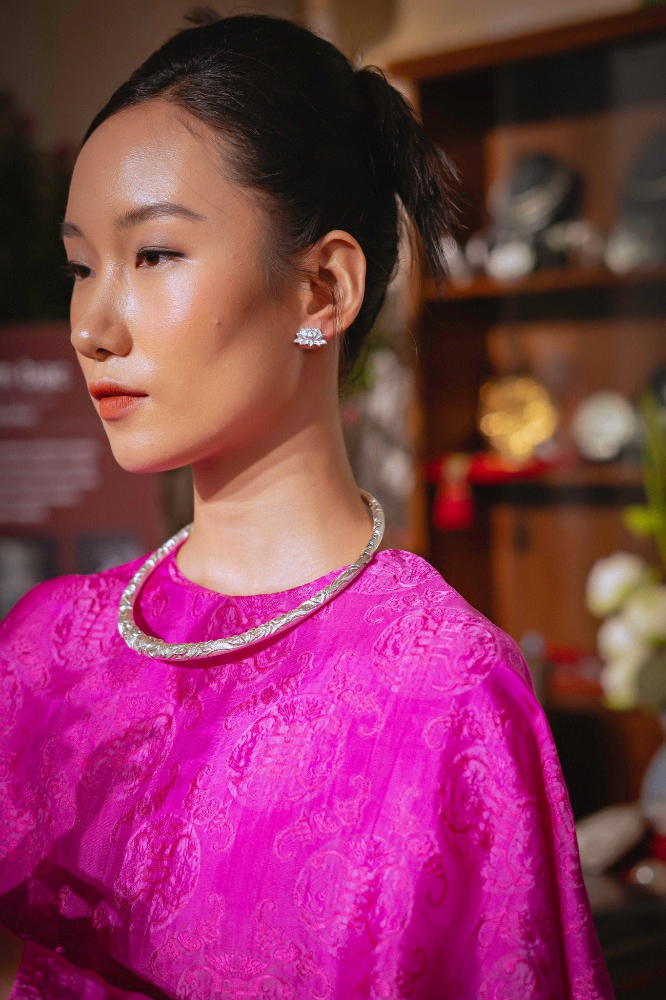 Woman wearing Bich Lien eternal lotus earrings - 99% pure silver Vietnamese artisan jewelry Hi De Maison