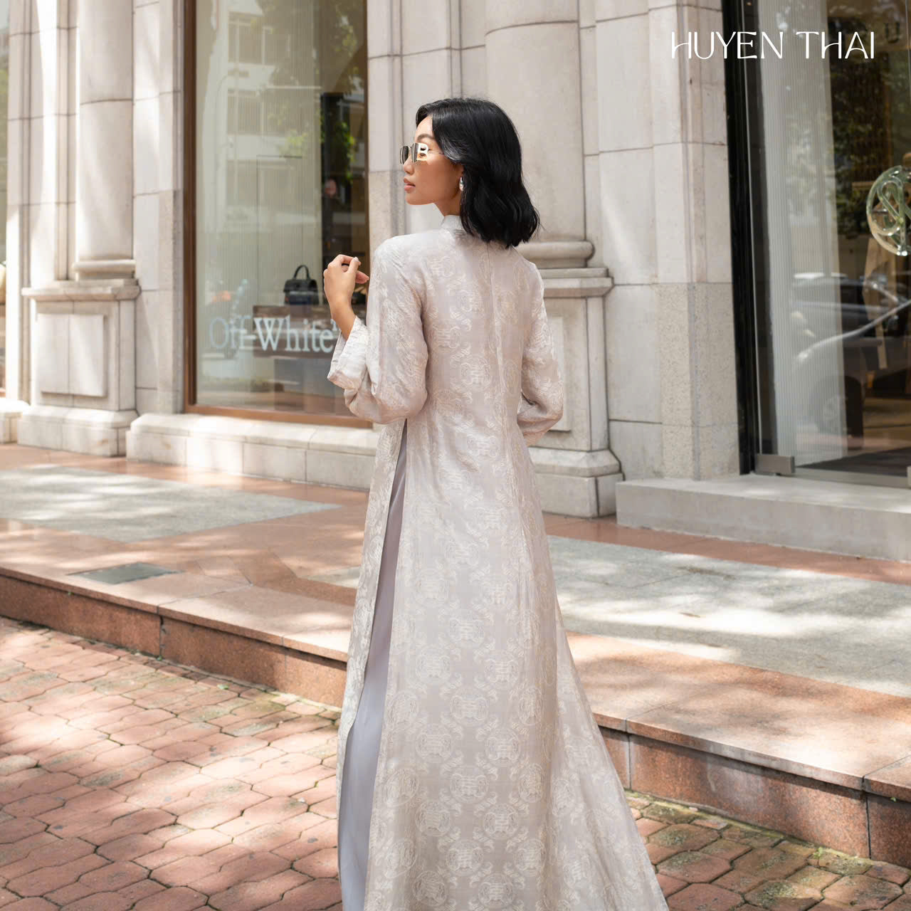 "Elegant ivory grey Ao Dai set by Huyen Collection, featuring modern jacquard silk design, traditional Vietnamese dress."