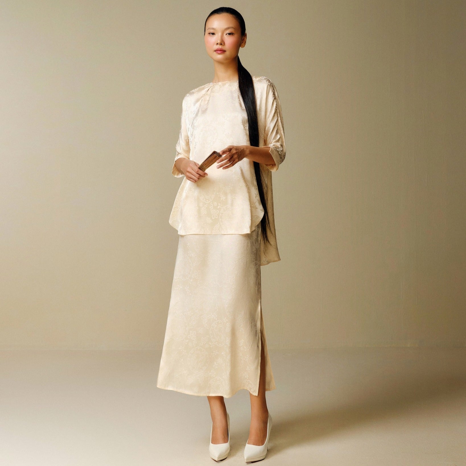 "Traditional Vietnamese dress 'Dong' in light yellow jacquard silk by Nam Phuong Y"
