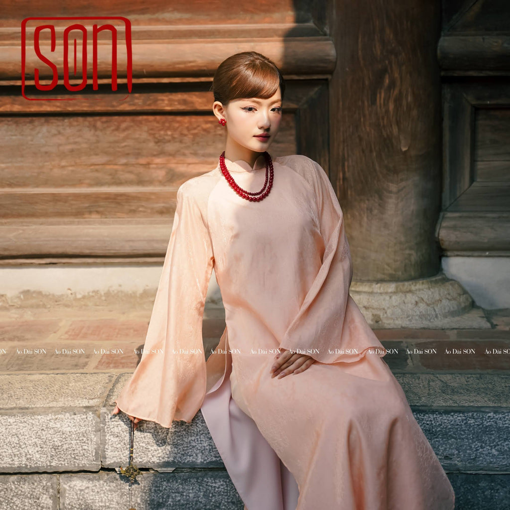 "Thy Son Ao Dai set in blush pink silk jacquard with floral pattern, traditional Vietnamese dress."