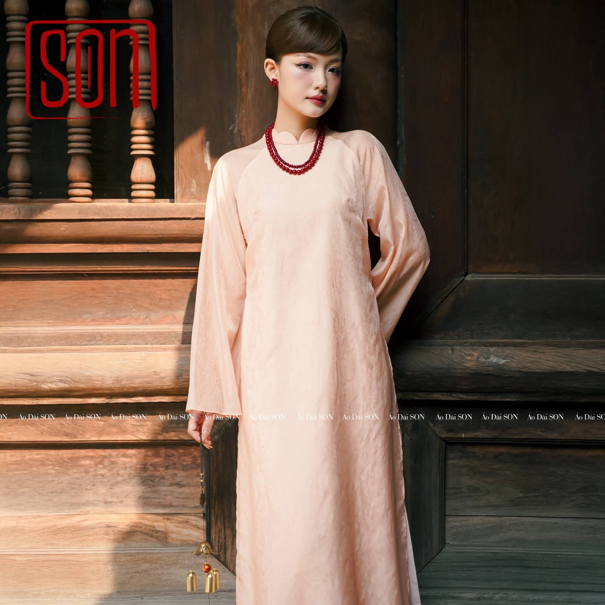 "Thy Son Ao Dai set in blush pink silk jacquard with floral pattern, traditional Vietnamese dress."