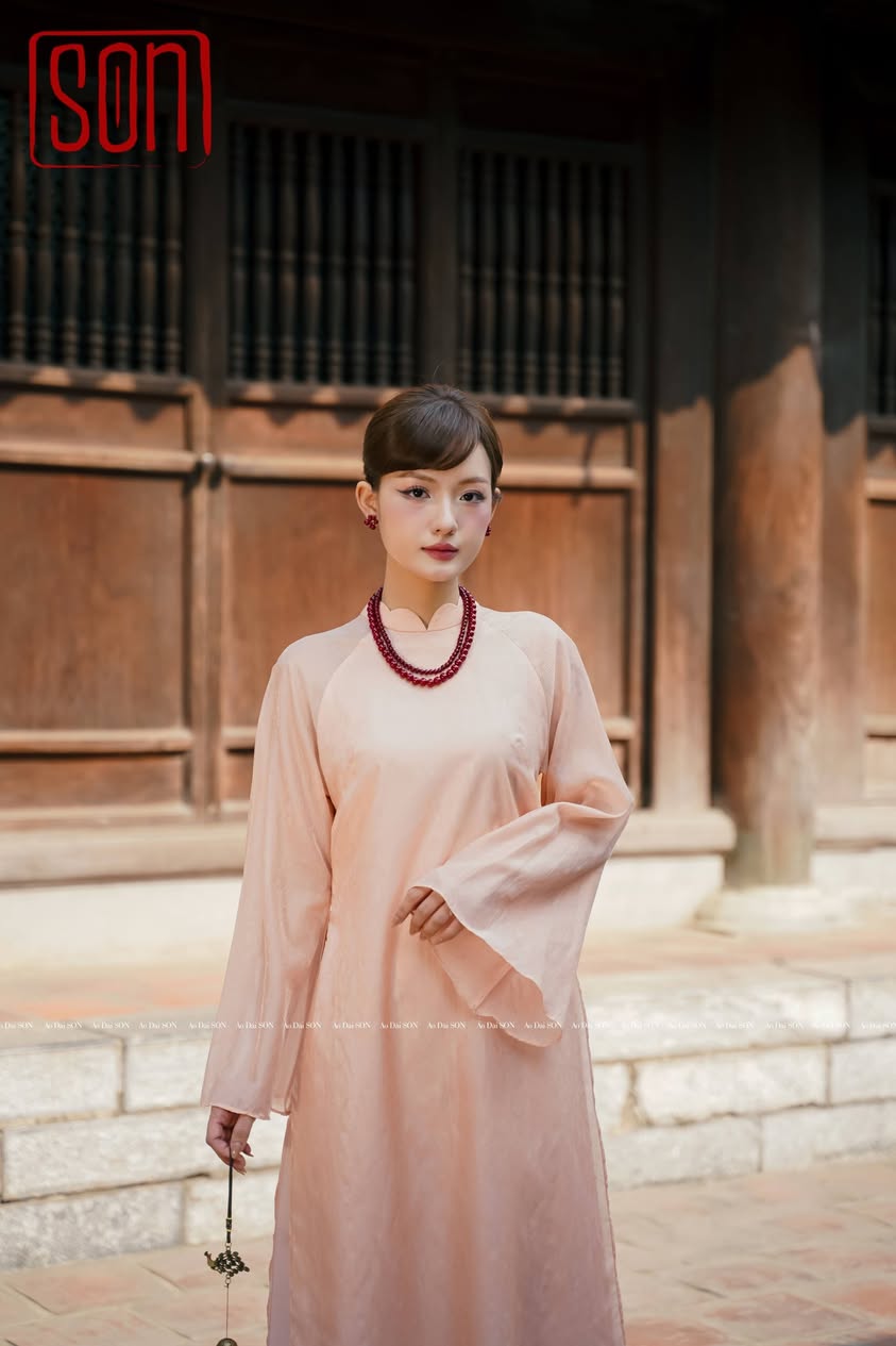 "Thy Son Ao Dai set in blush pink silk jacquard with floral pattern, traditional Vietnamese dress."
