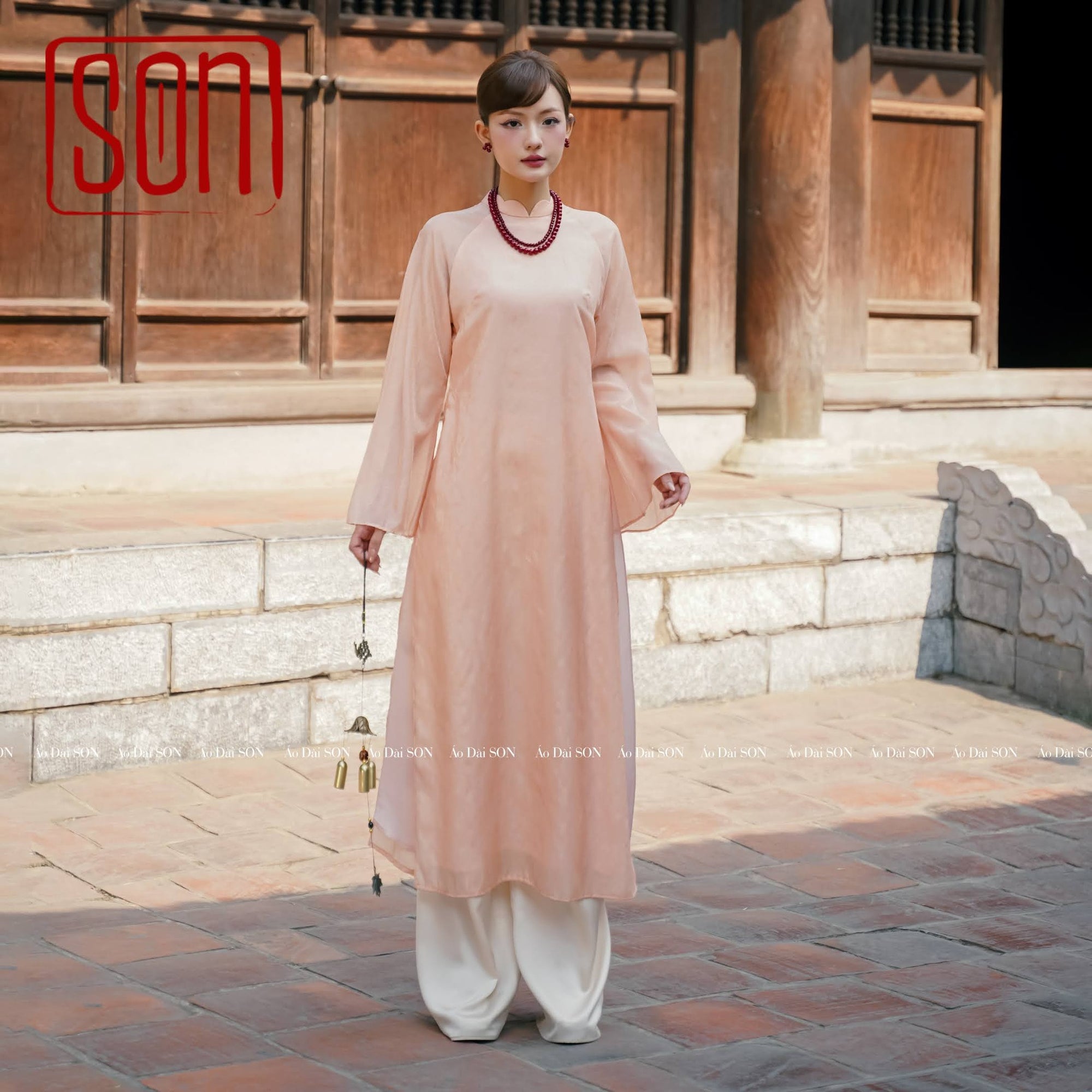 "Thy Son Ao Dai set in blush pink silk with floral jacquard, traditional Vietnamese dress."