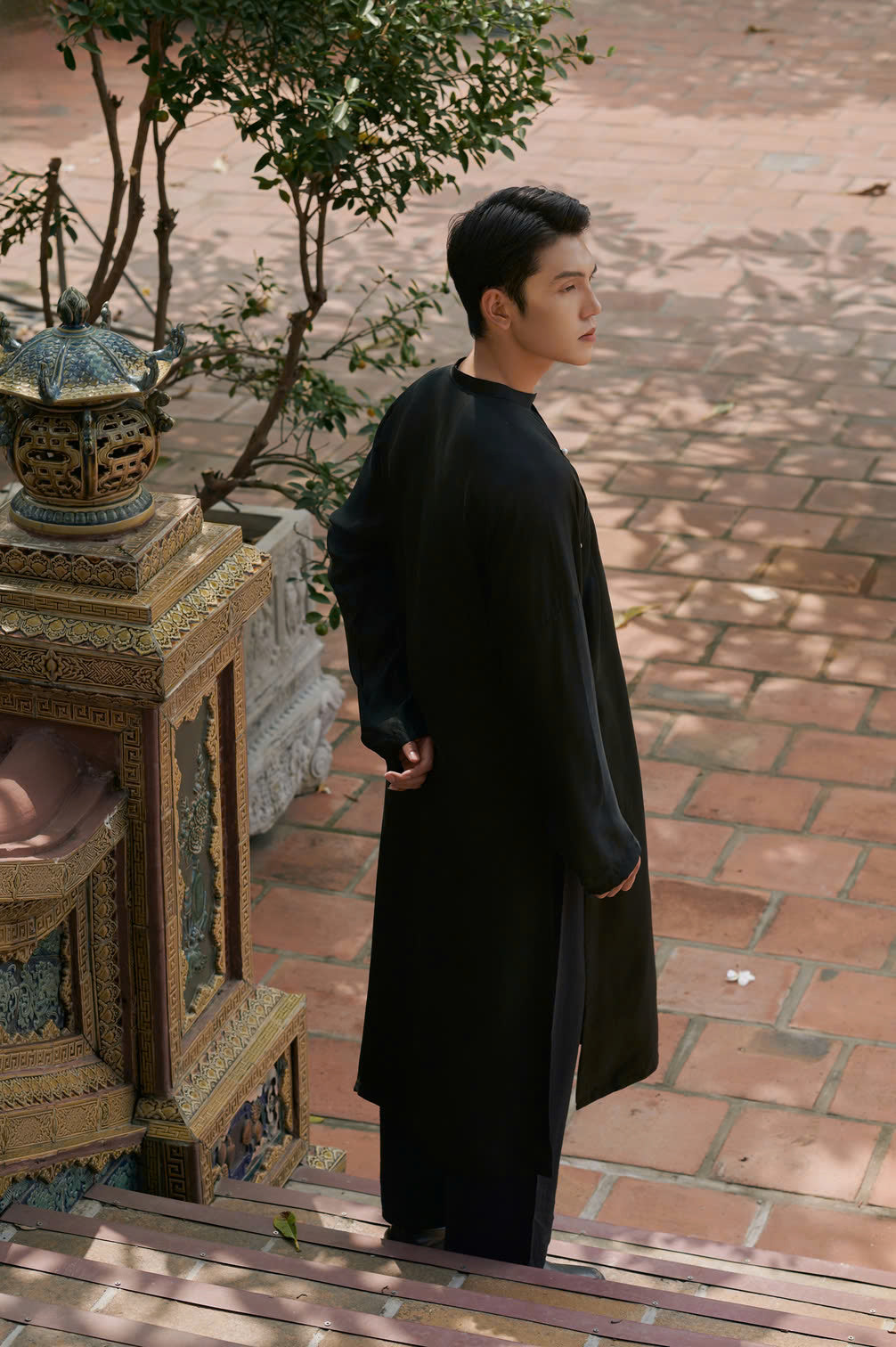 "Traditional Vietnamese Ao Dai for Men in black artisan silk by Moc, blending modern and cultural heritage."