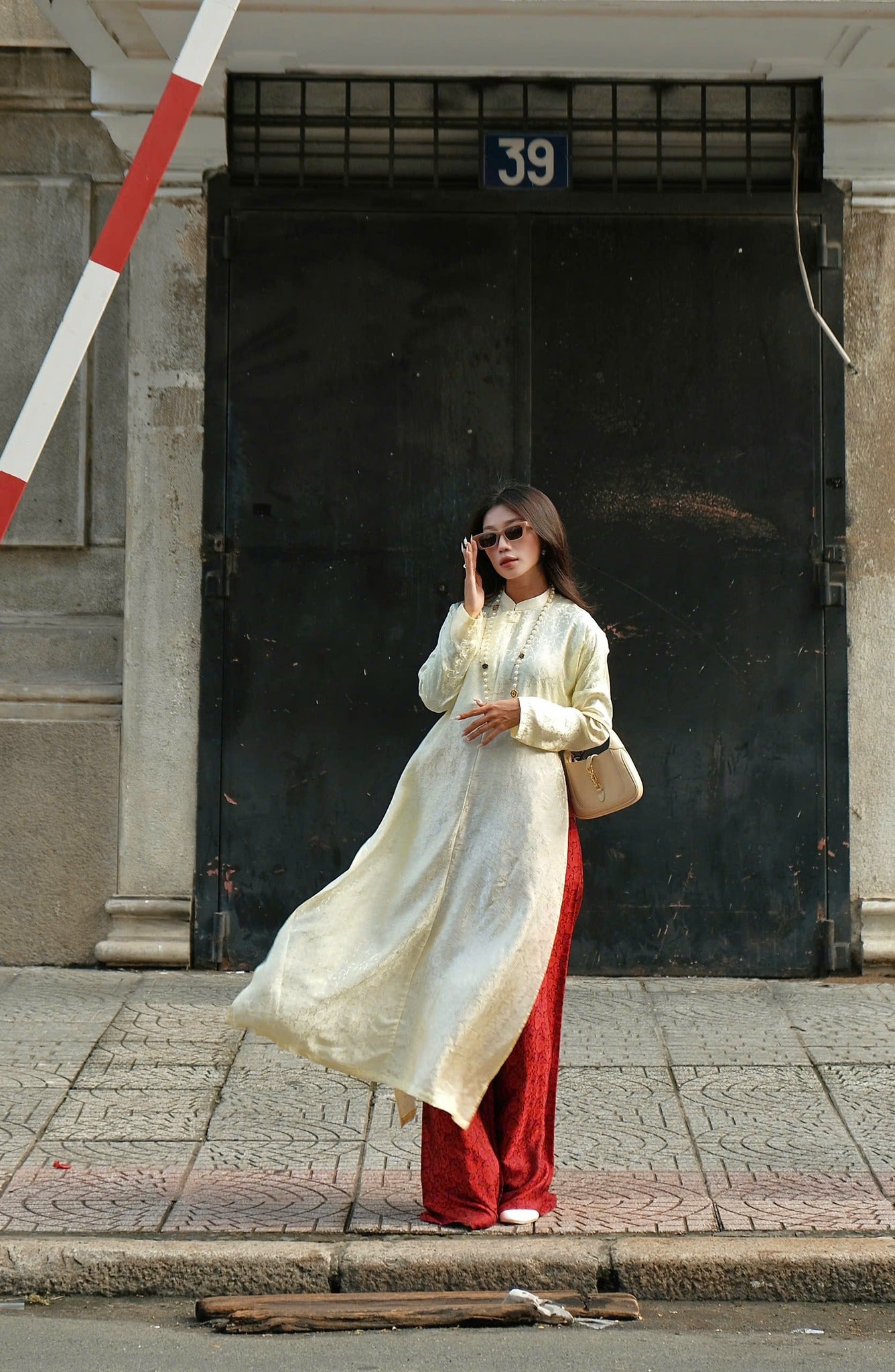 "Traditional Vietnamese Ao Dai set in cream silk with red chrysanthemum pattern, cultural attire by Moc."