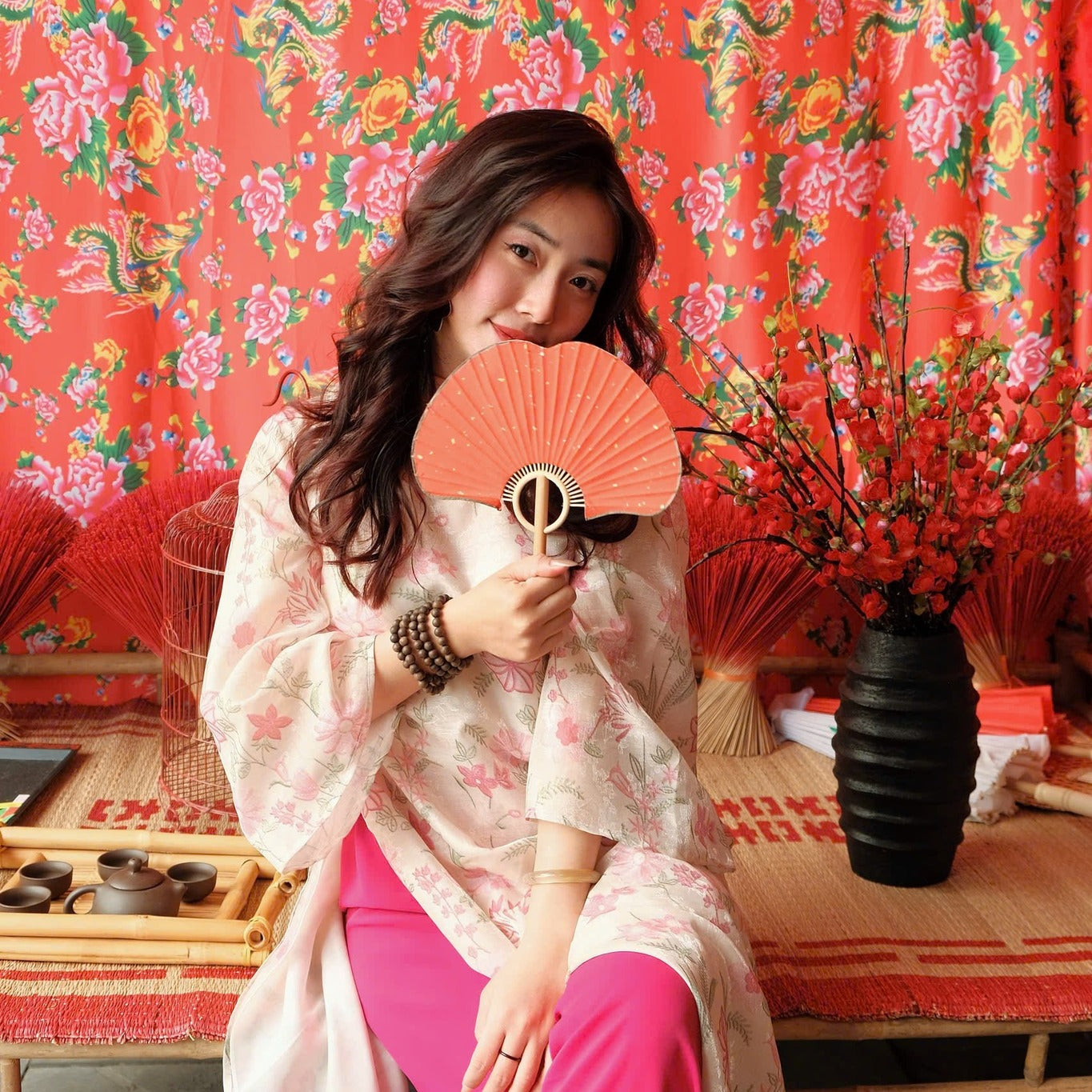 "Thieu Hoa Jacquard Ao Dai Set in pink silk with floral embroidery, traditional Vietnamese dress."