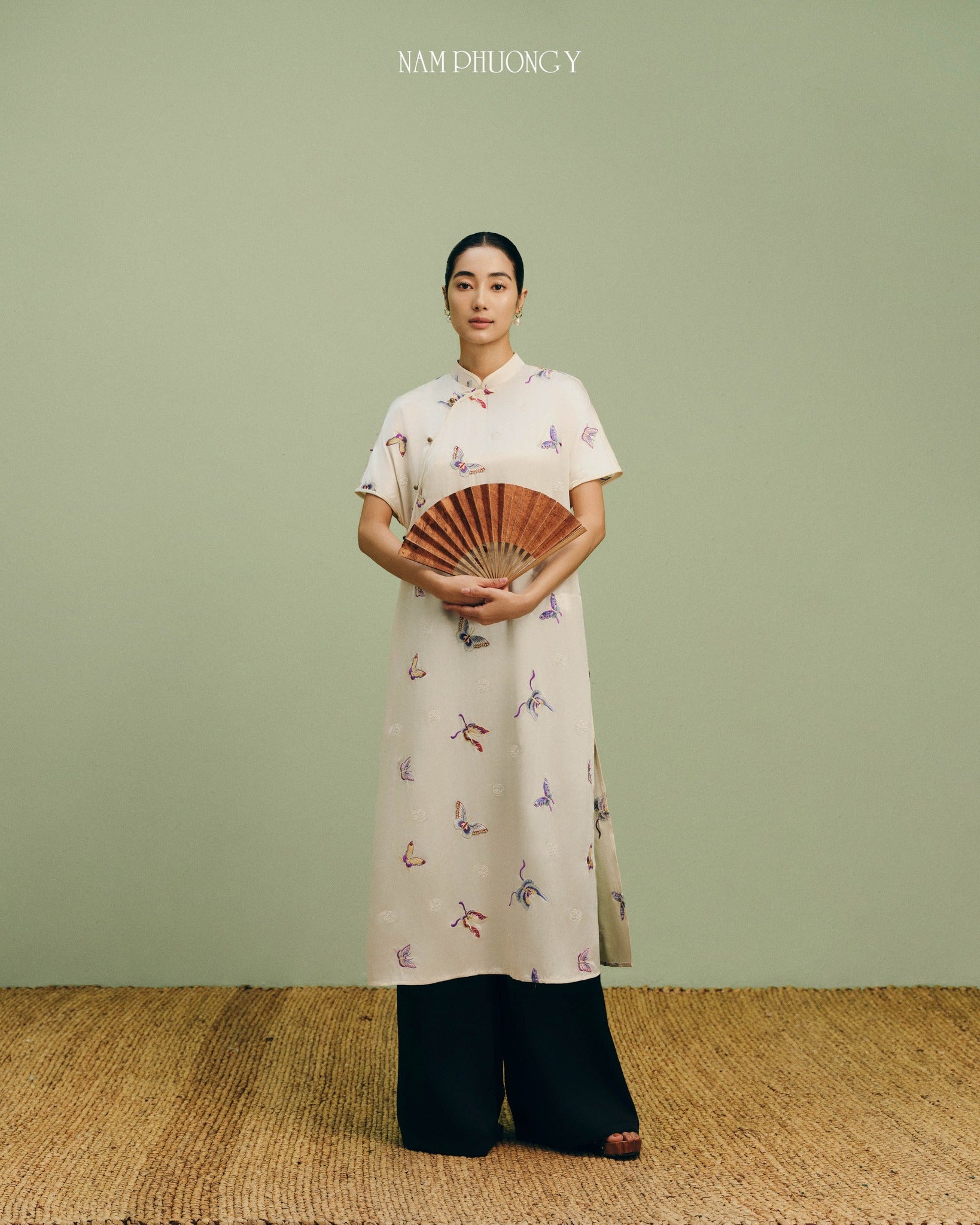 "Premium ivory silk Ao Dai with colorful embroidery, traditional Vietnamese dress by Nam Phuong Y."