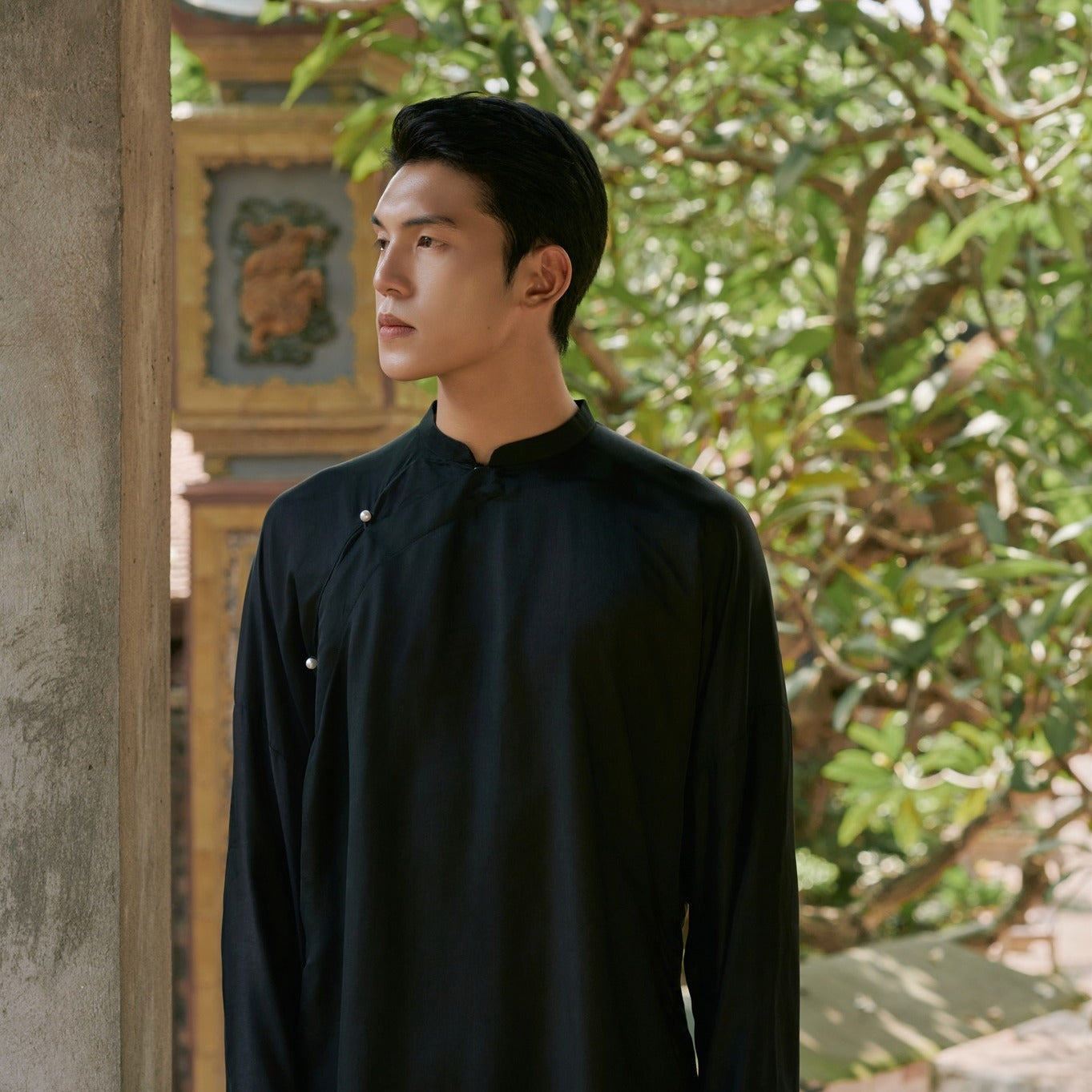 "Traditional Vietnamese Ao Dai for Men in black wormsilk by Moc, cultural heritage attire."