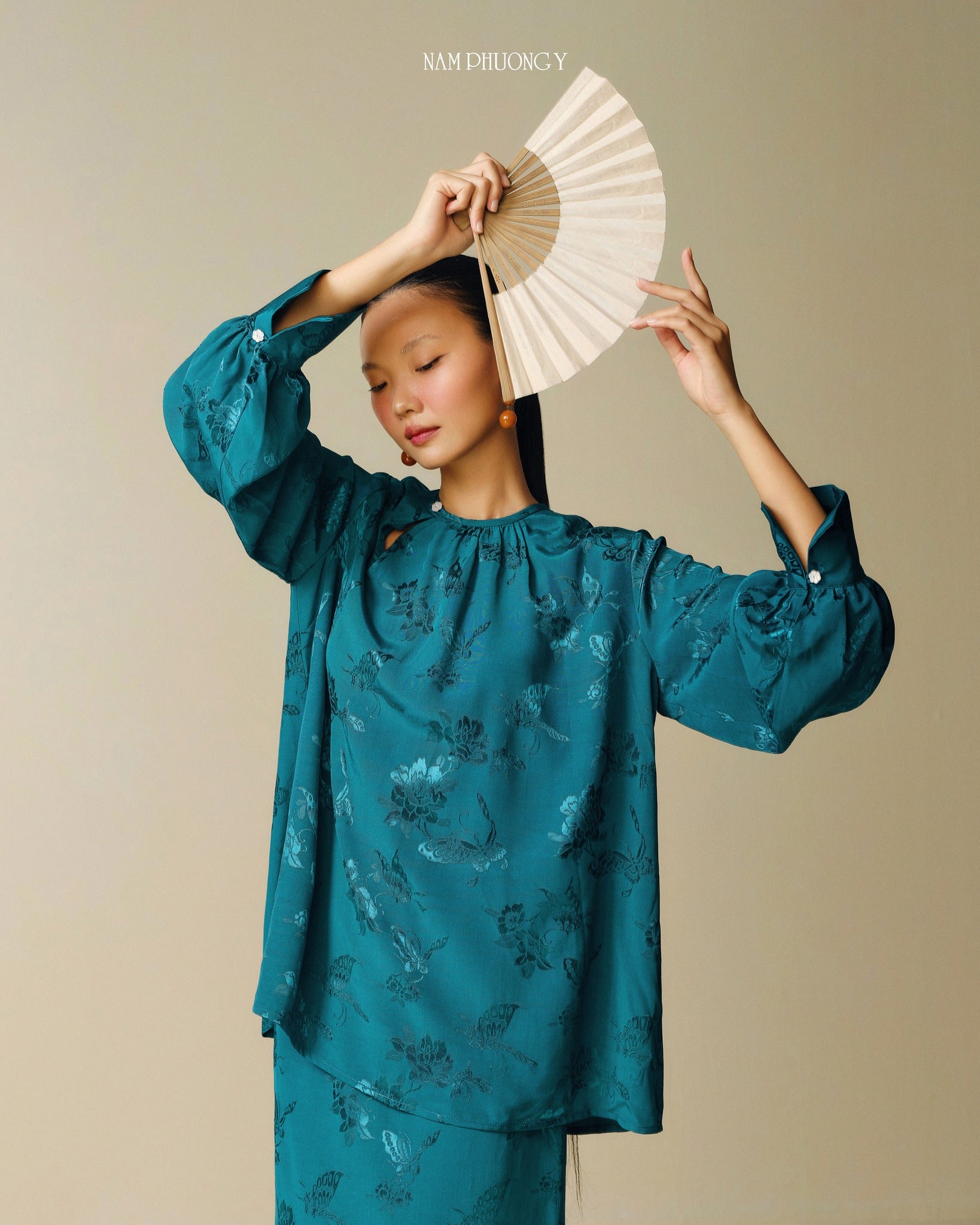 "Traditional Vietnamese dress 'Dong' in dark teal jacquard silk by Nam Phuong Y"