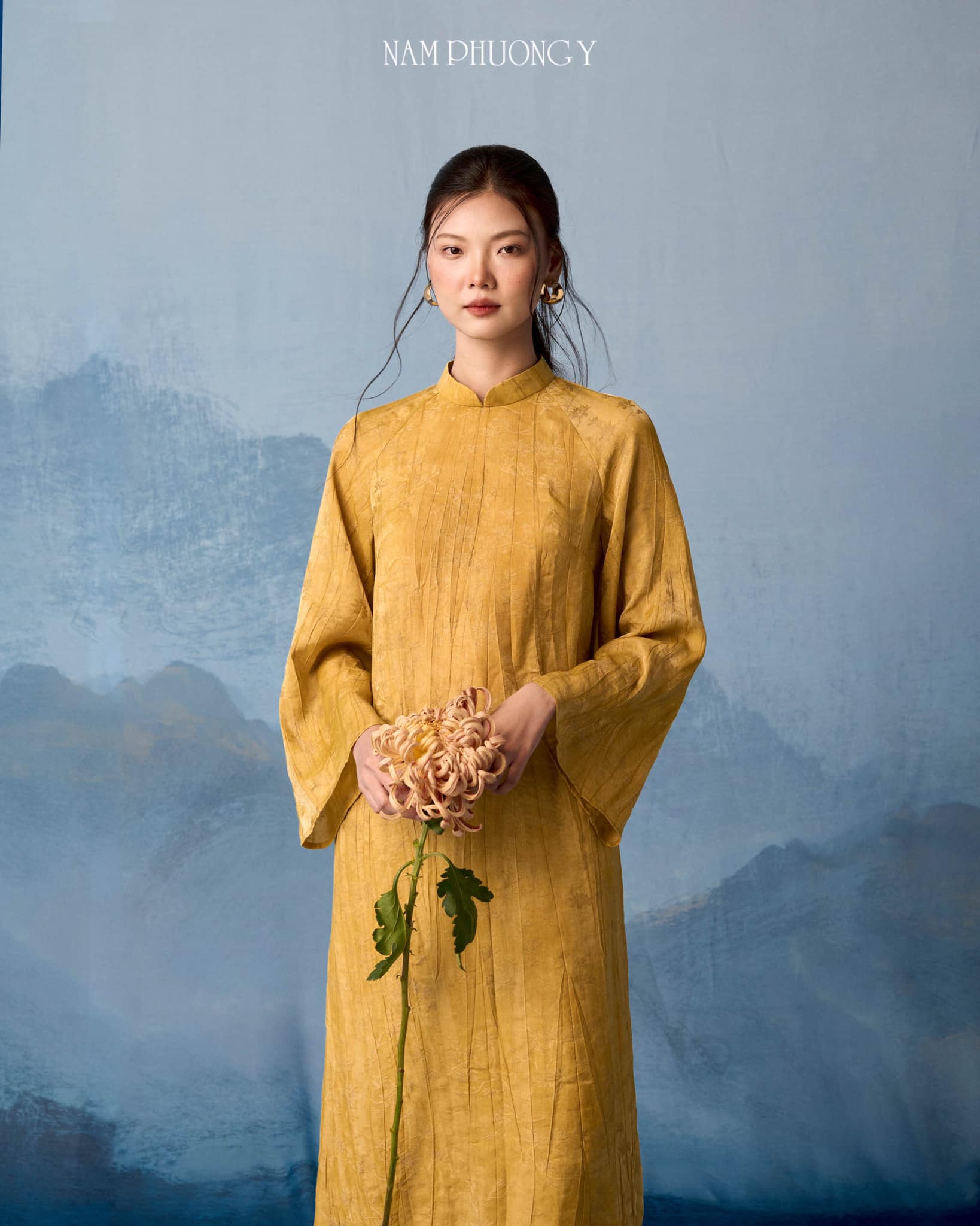 "Hoang Thu Premium Natural Silk Ao dai Set in Ochre by Nam Phuong Y, traditional Vietnamese dress in gold silk with modern design."