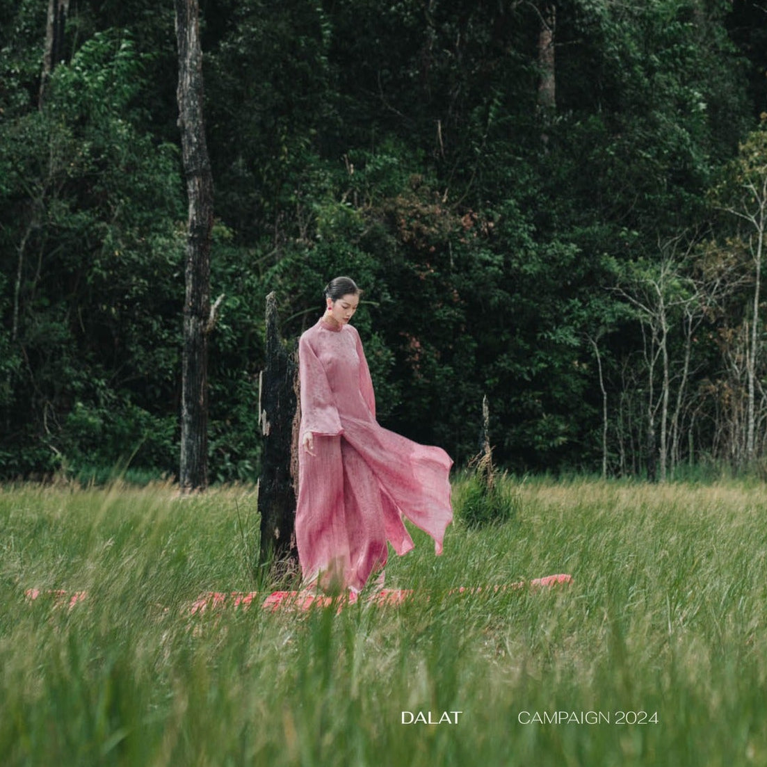 "Nhu Khue" pink silk Ao dai set by Nam Phuong Y, traditional Vietnamese dress in natural setting.