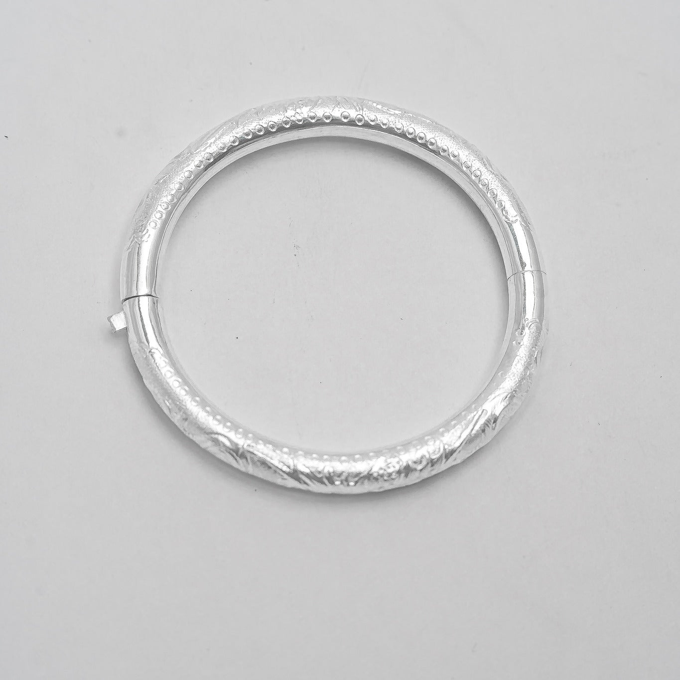 Linh Văn – Hollow Bangle in Lotus or Dragon Pattern - flat lay display in silver by HI de Maison