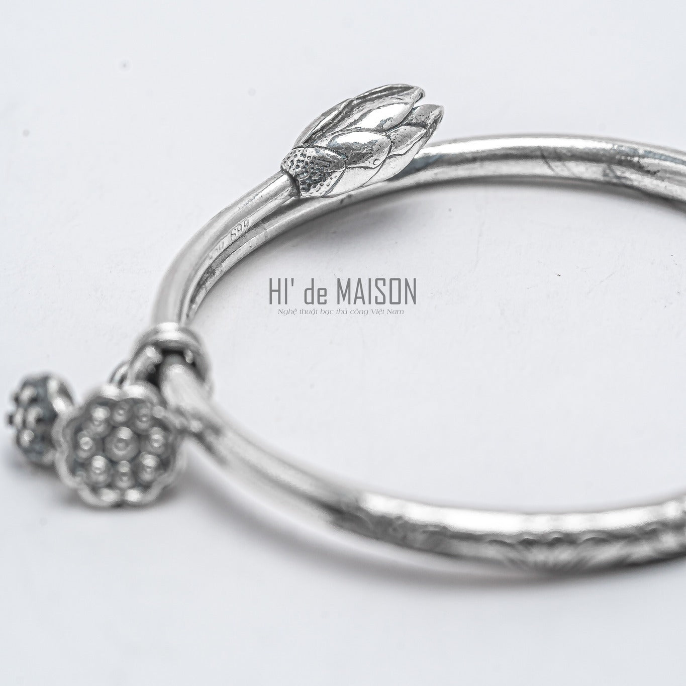 "Fine silver lotus bud bangle 'Hạ Liên' by HI de Maison, artisan-crafted with modern design."