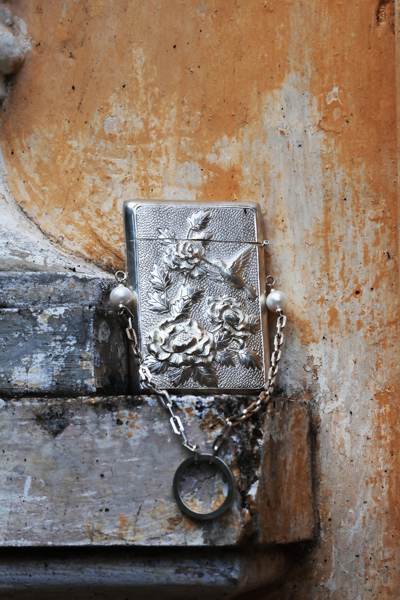 Woman holding Bach Hoa silver clutch with delicate pearl accents and silk tassel charm - Vietnamese artisan jewelry