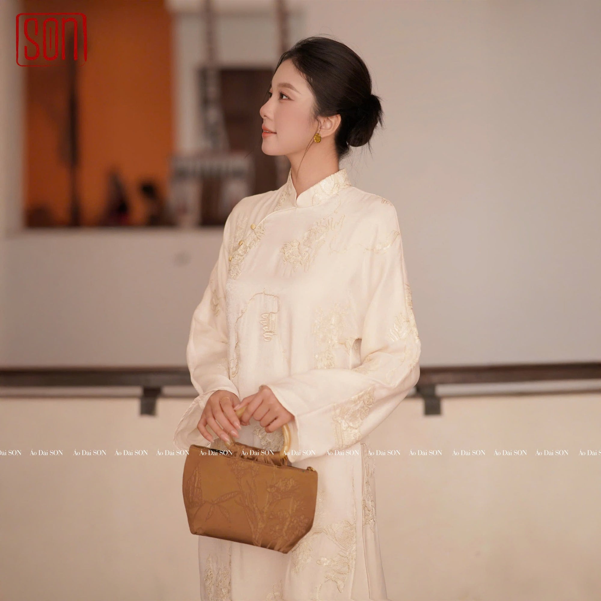 "White 'Tuyet Son' Ao Dai set by SON in silk jacquard with floral embroidery, traditional Vietnamese dress."