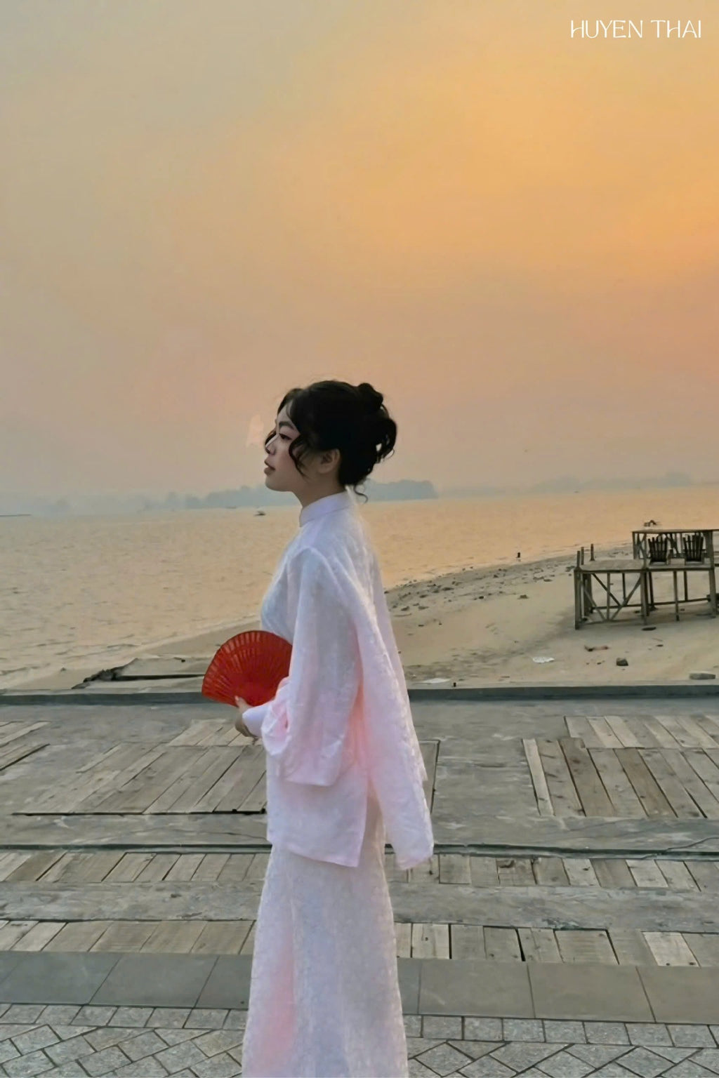 "KY Ao-Ngan pink silk Ao dai by Huyen Thai Collection, modern Vietnamese dress with artisan jacquard pattern."