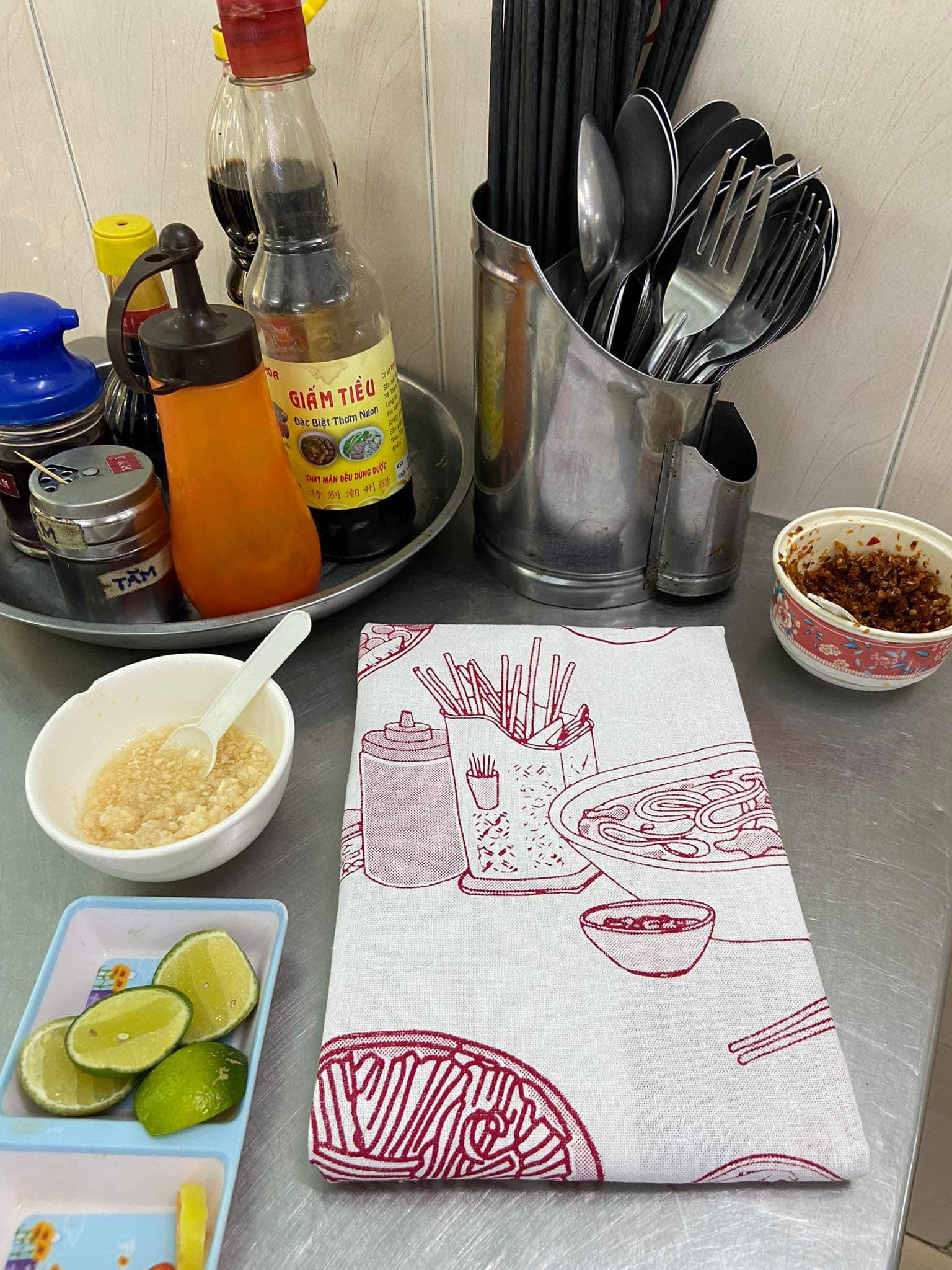 "Vietnam in a Bowl Kitchen Towel by Bat-trang, red design with Vietnamese food illustrations, cultural authenticity."