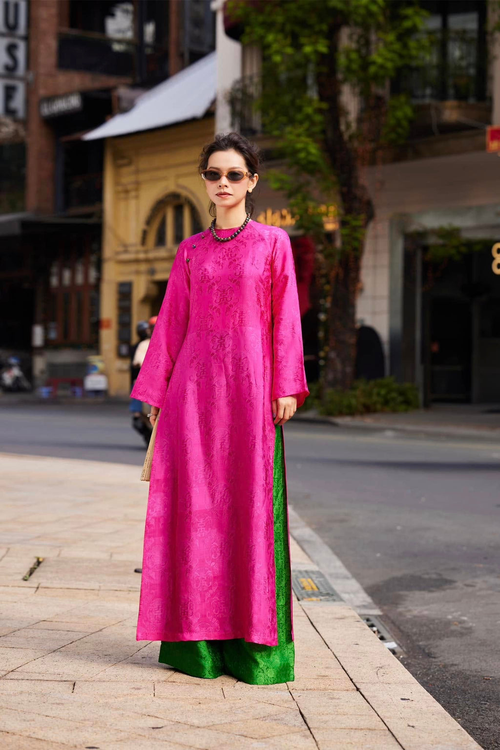 Woman wearing Fuchsia Reverie imperial fuchsia áo dài with stone buttons and signature straight-cut silhouette - Vietnamese traditional dress