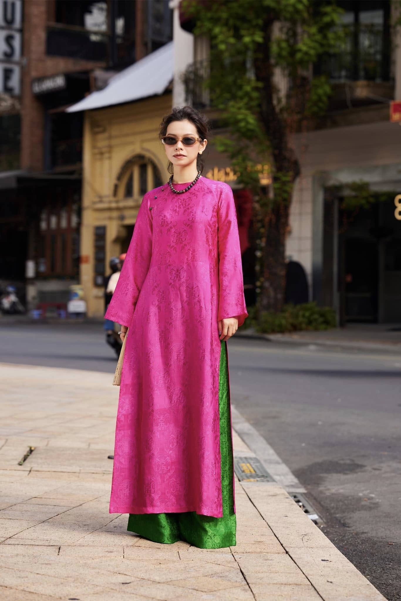 Woman wearing Fuchsia Reverie imperial fuchsia áo dài with stone buttons and signature straight-cut silhouette - Vietnamese traditional dress