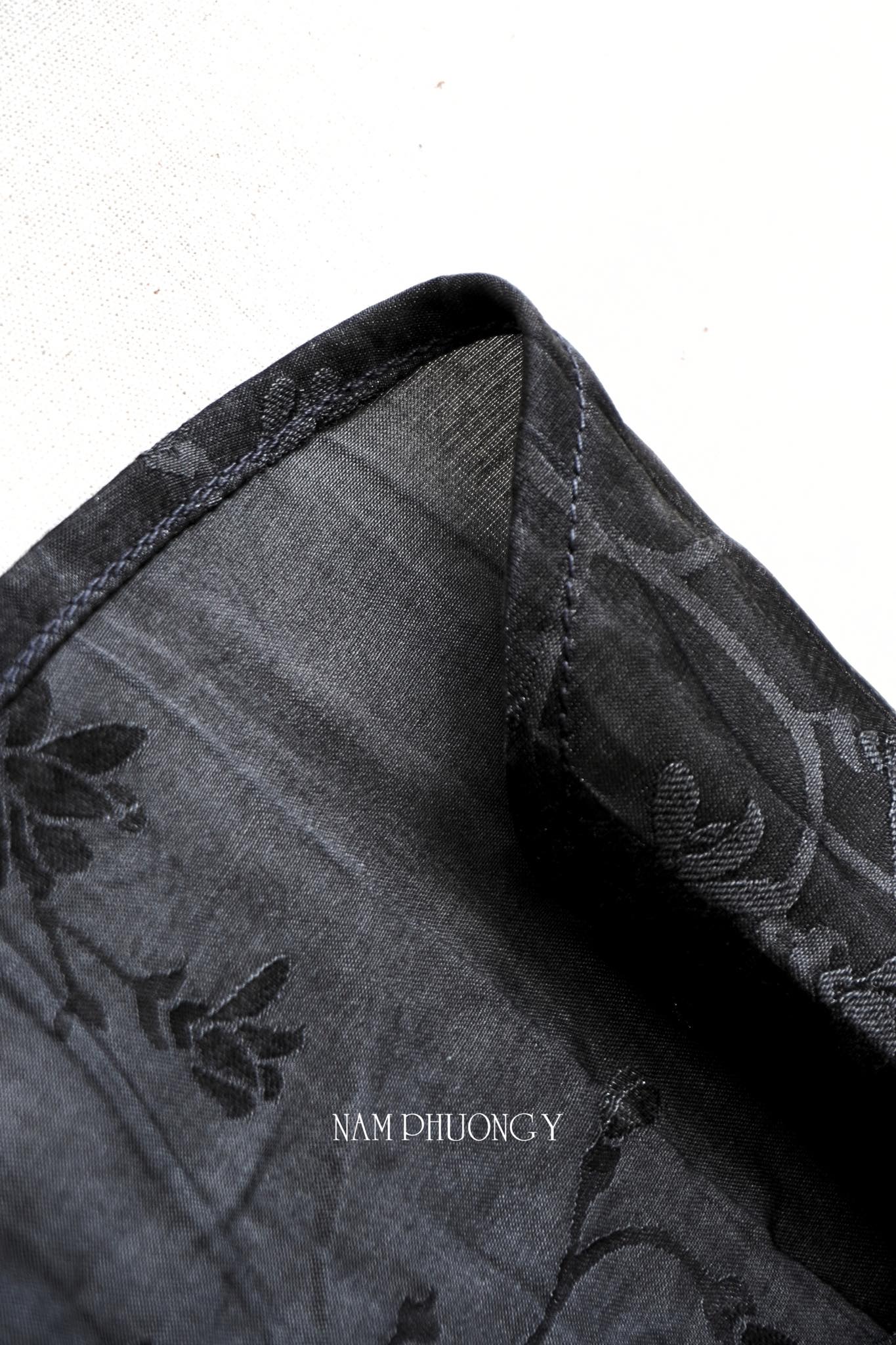 Bich Lien sleeveless black silk ao dai with green pants detail view - traditional Vietnamese dress by Nam Phuong Y