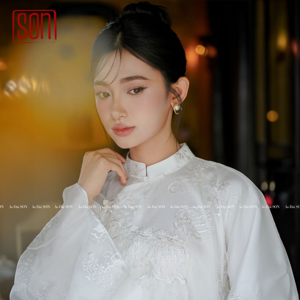 "Uyen Son Embroidered Organza Ao Dai set in white silk with floral patterns, traditional Vietnamese wedding dress."