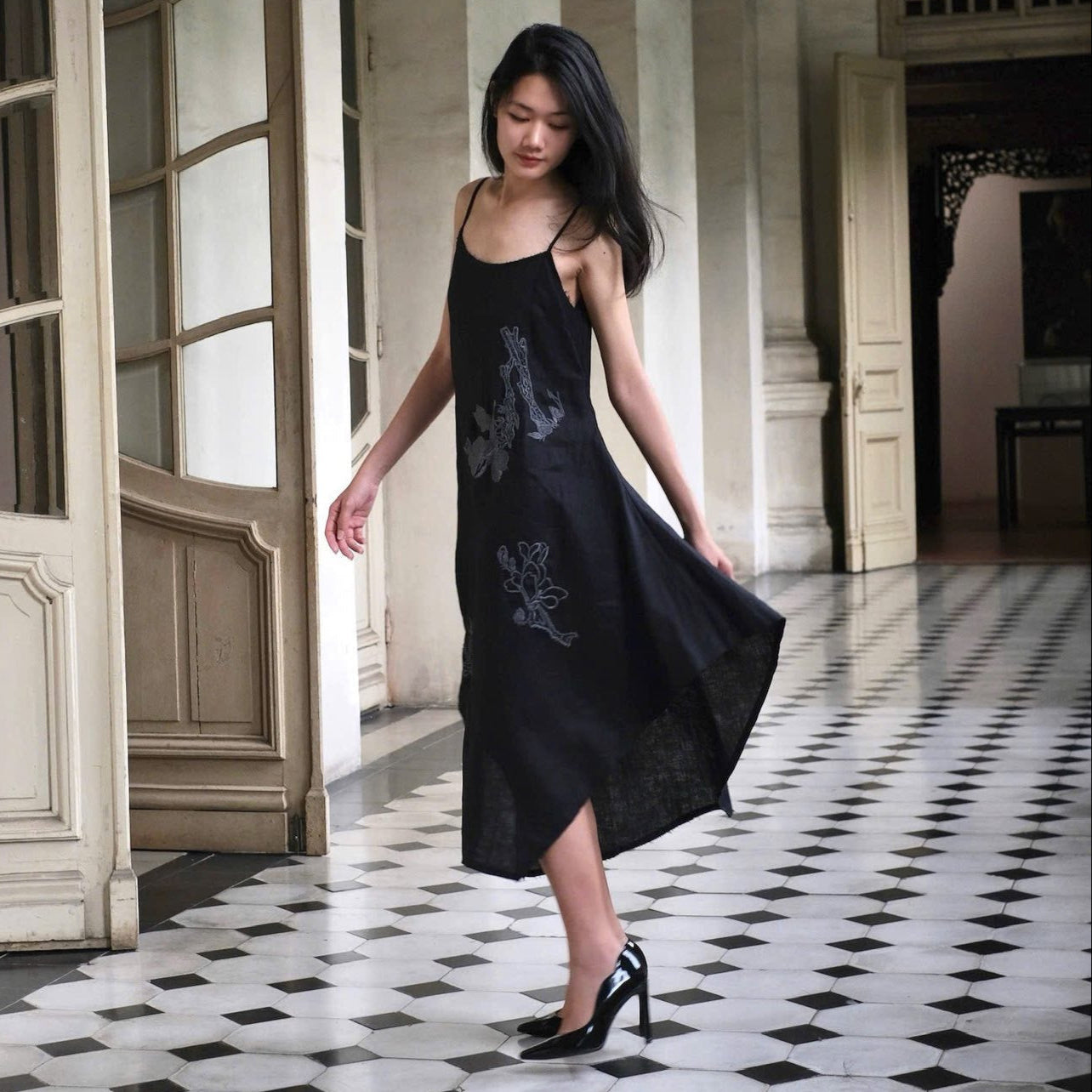 "Magnolia" embroidered linen slip dress in noir by Huulala, black floral pattern.