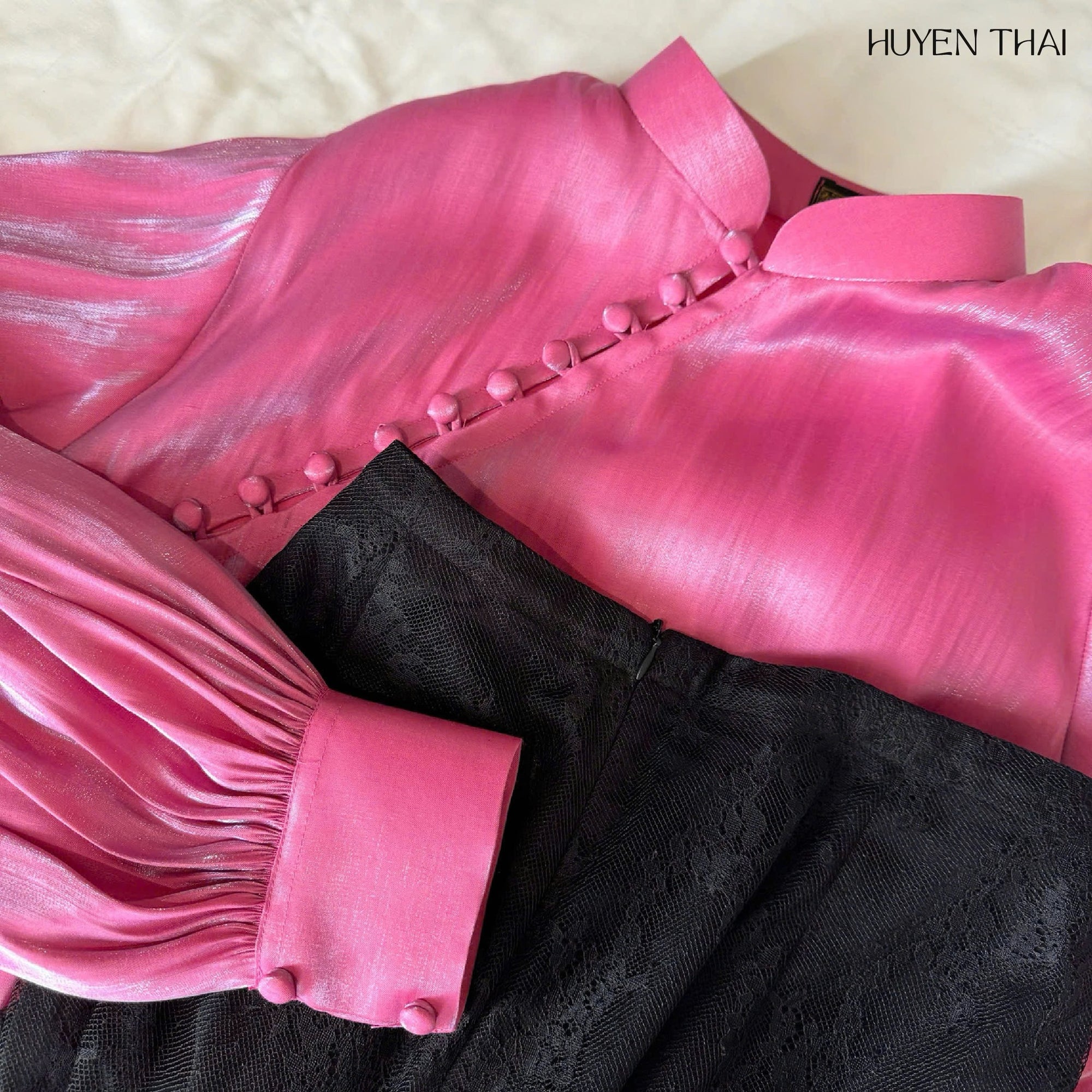 "Traditional Vietnamese Ao Dai set in pink silk with black lace skirt by Huyen Collection"