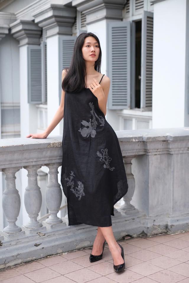 "Magnolia embroidered linen slip dress in noir by Huulala, black with floral pattern"