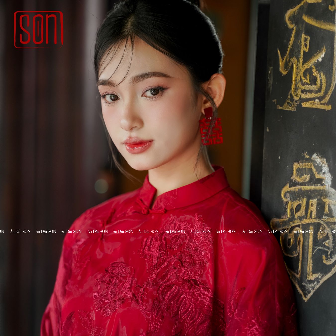 "Uyen Son red embroidered organza Ao dai, traditional Vietnamese wedding dress, floral silk design."