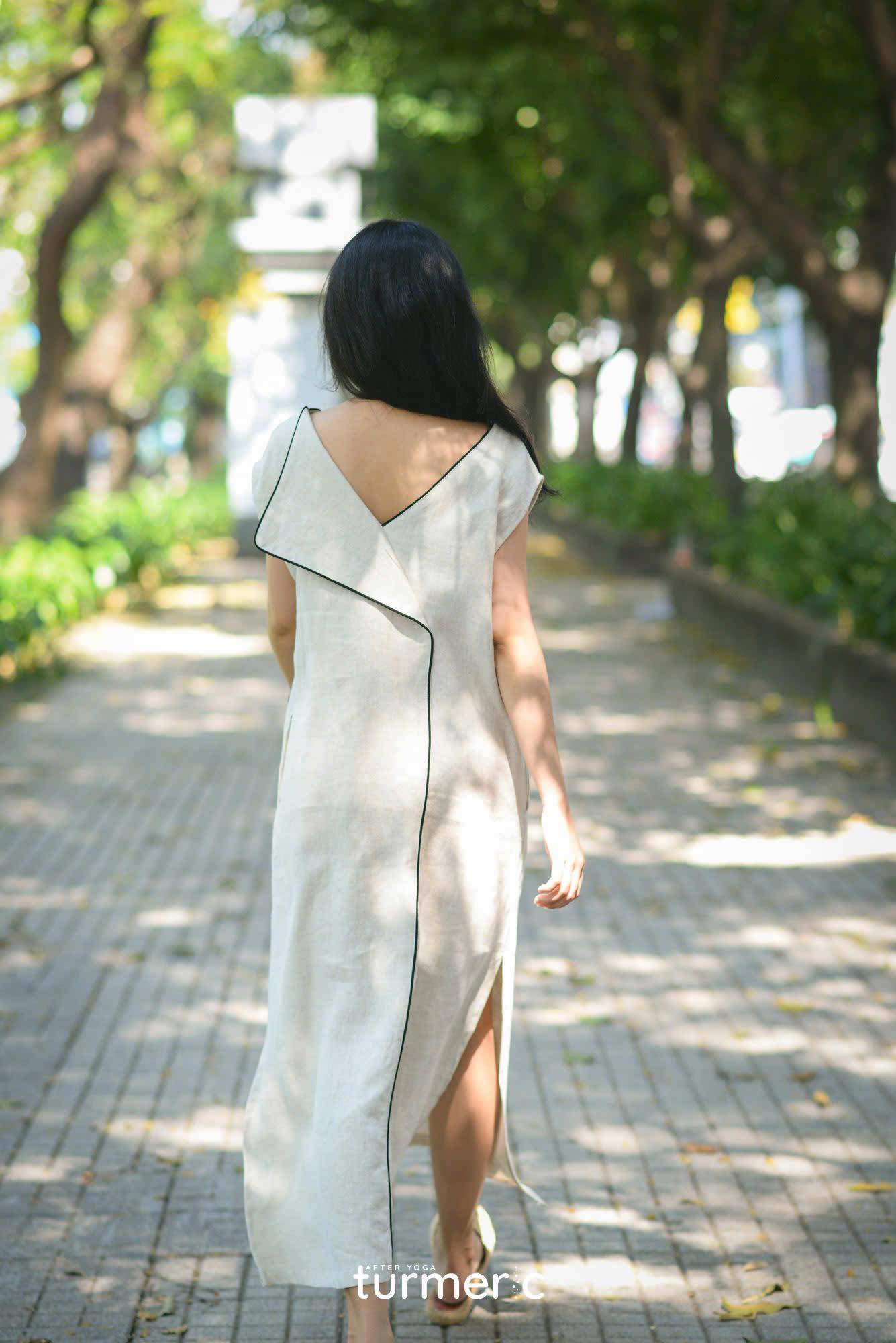"Rosa linen maxi dress in cream with modern design, featuring a sleek black trim, by Turmeric."