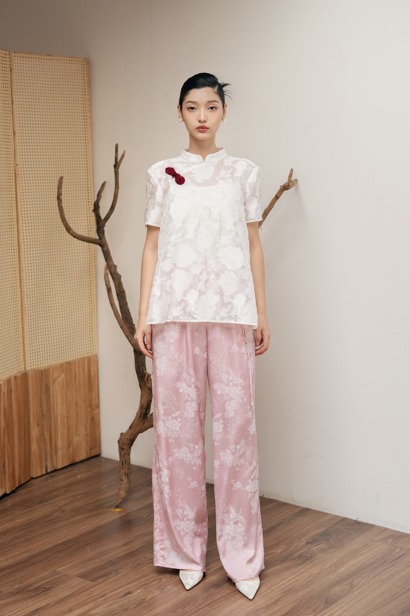 "Lam Khue Jacquard Silk Mandarin-Neck Top in Pastel Pink by Hy Phuong, traditional Vietnamese floral design."