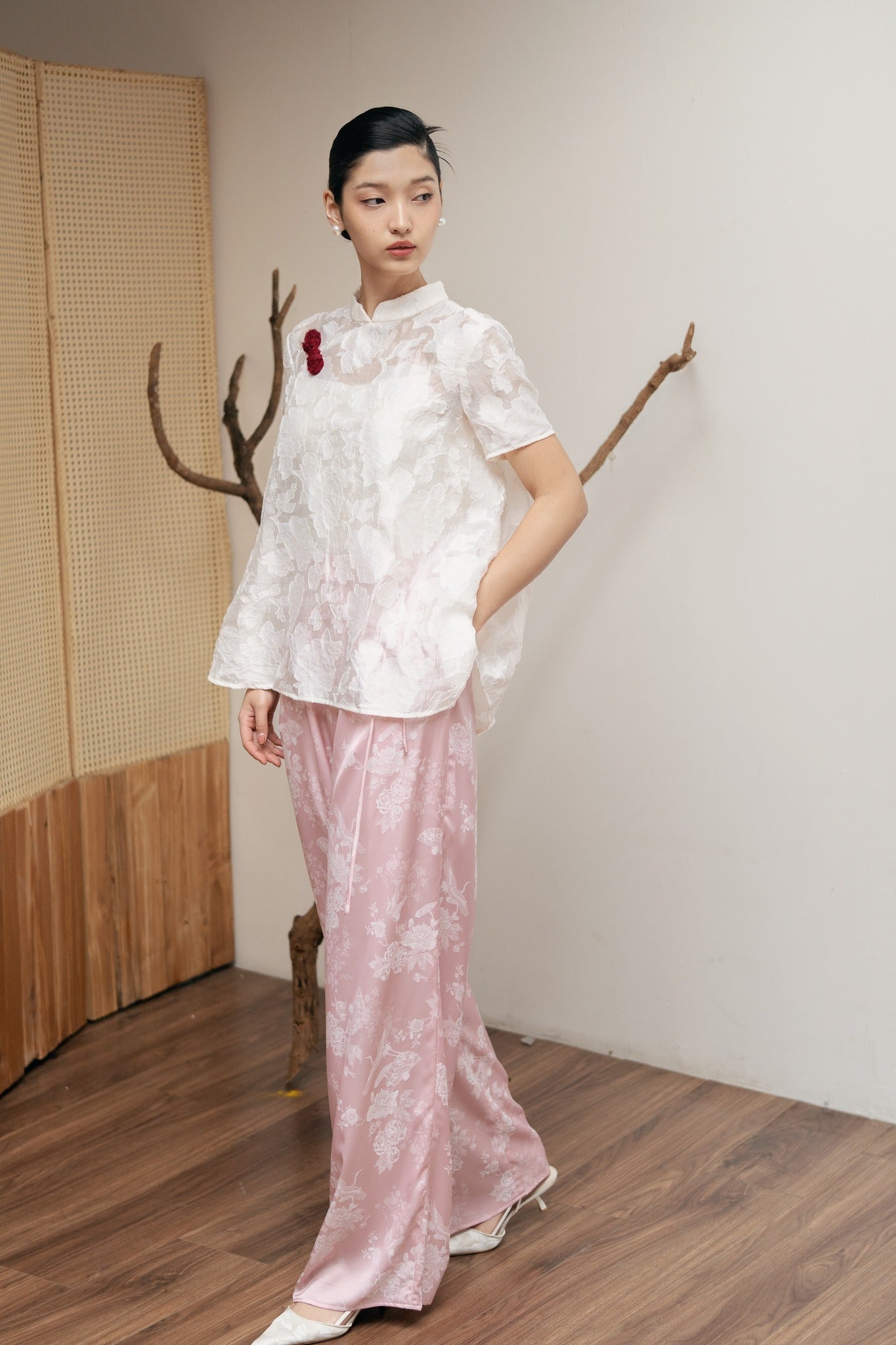 "Lam Khue Jacquard Silk Mandarin-Neck Top in Pastel Pink by Hy Phuong, traditional Vietnamese floral design."