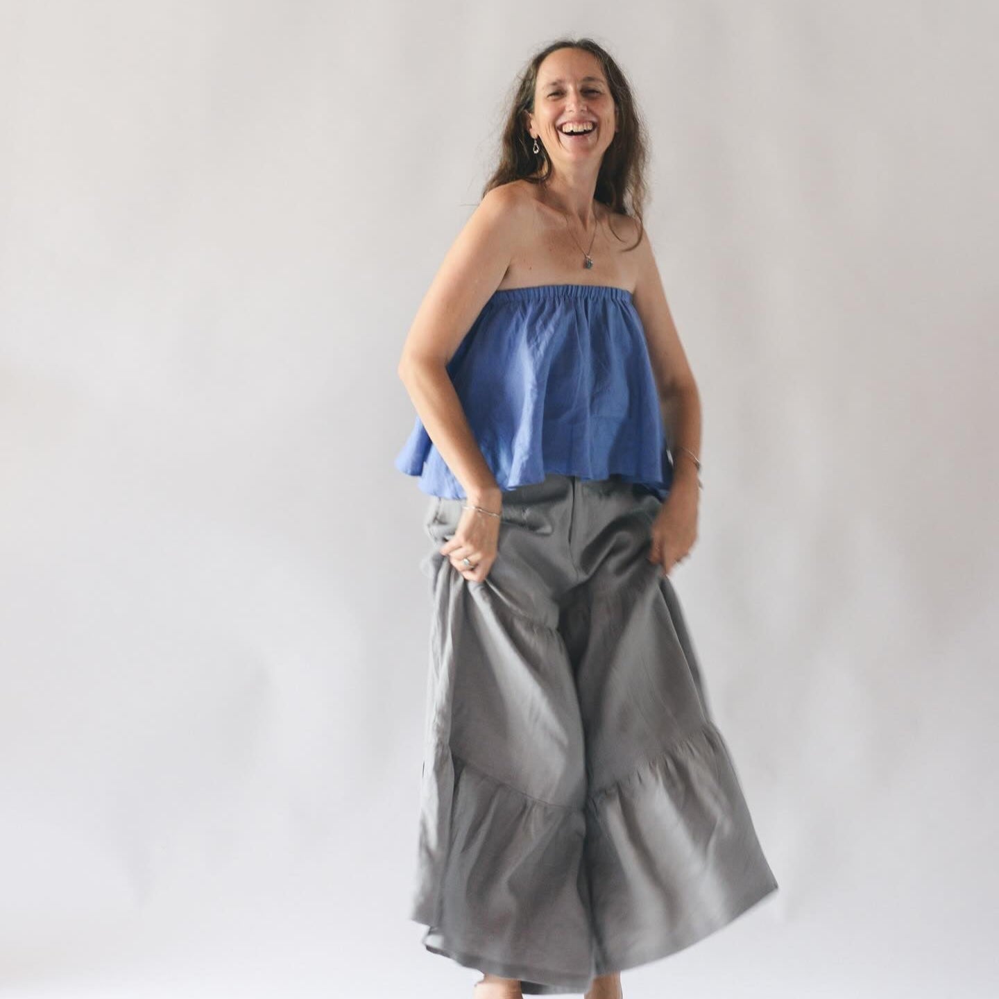 "Balloon pants in light grey linen by Turmeric, paired with a blue strapless top"