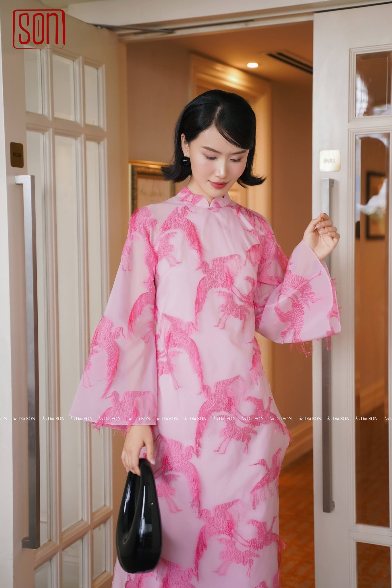 "Pink embroidered organza Ao dai set from SON's wedding collection, traditional Vietnamese dress."