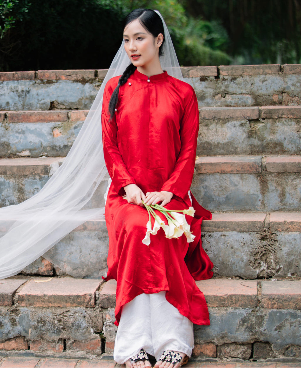 "Traditional Vietnamese 'Ngu Than' Ao Dai set in red silk by Moc, featuring artisan craftsmanship and cultural authenticity."