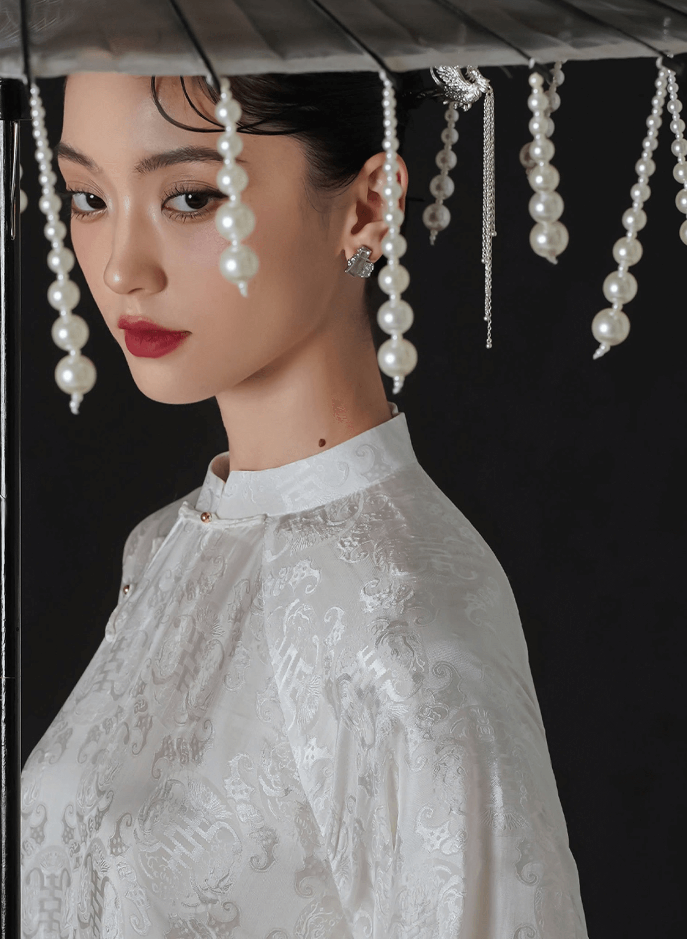 "Hy Loan Ao Dai Set by Lalin in white silk, traditional Vietnamese dress with modern woven patterns."