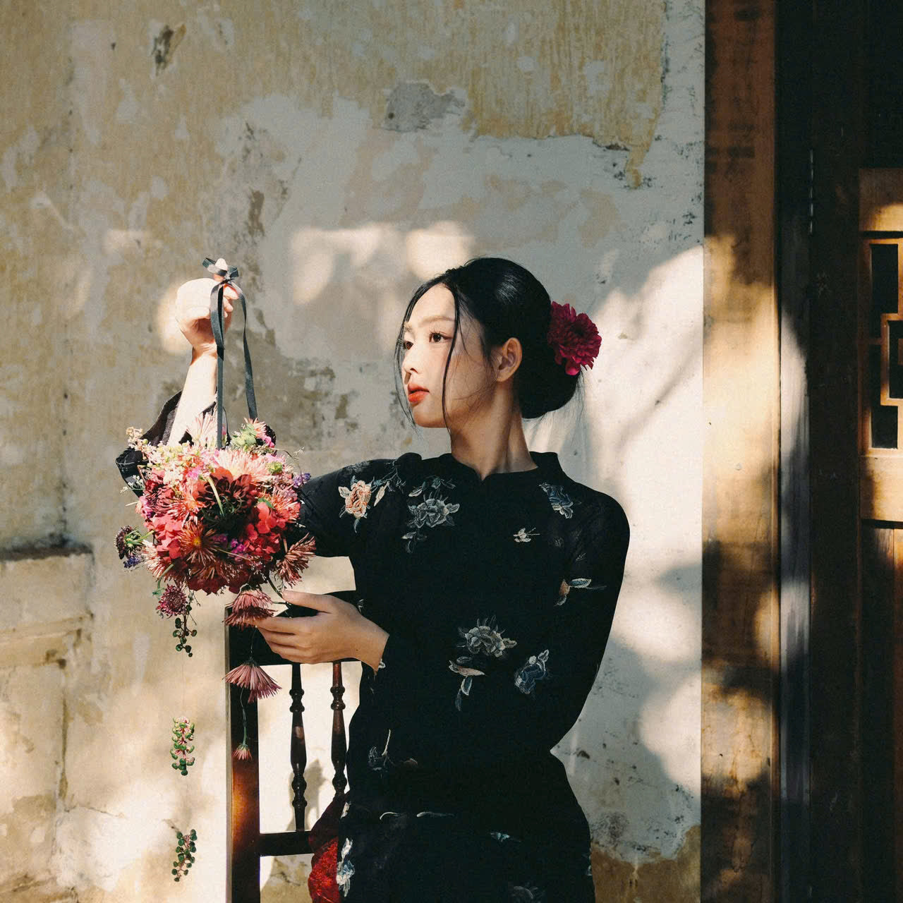 "Traditional Vietnamese Ao dai set in black silk with floral embroidery, cultural elegance."