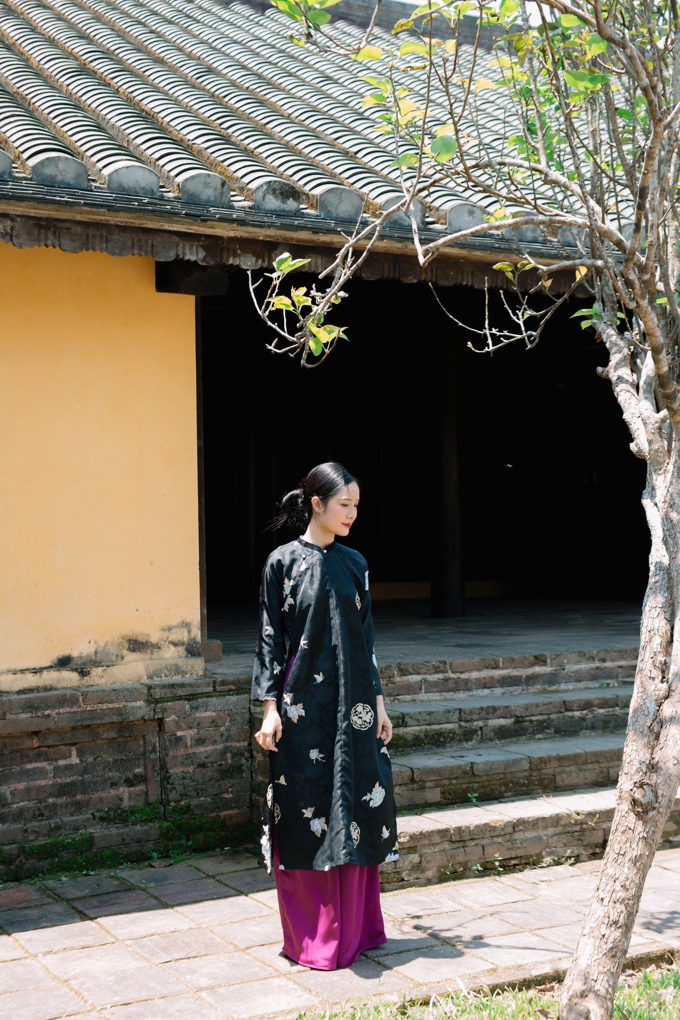 "Traditional Vietnamese Ao dai set in black silk with floral embroidery by Moc"