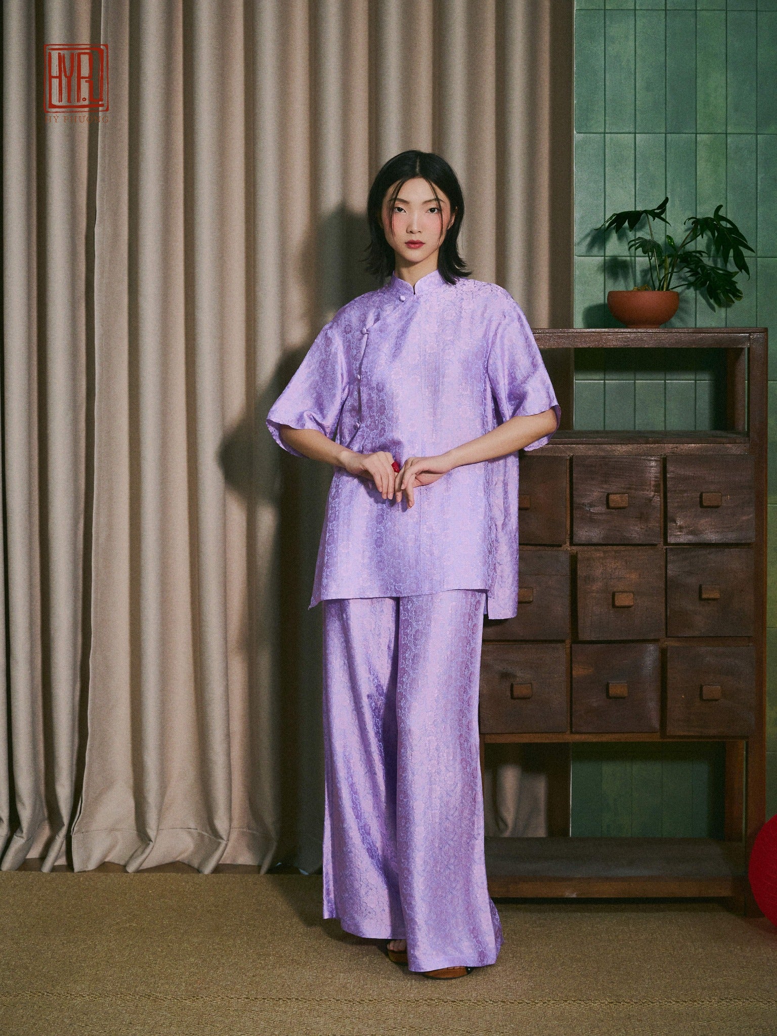 Vietnamese Ao Dai - Ninh Van Set - Mandarin-neck Wormsilk in Tangerine & Bright Teal - front view in purple by Hy Phuong