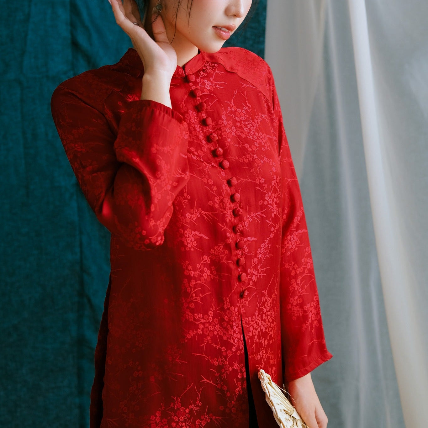 Side profile of Vietnamese áo bà ba in scarlet showing traditional Ba Ba silhouette with relaxed fit and hand-finished details