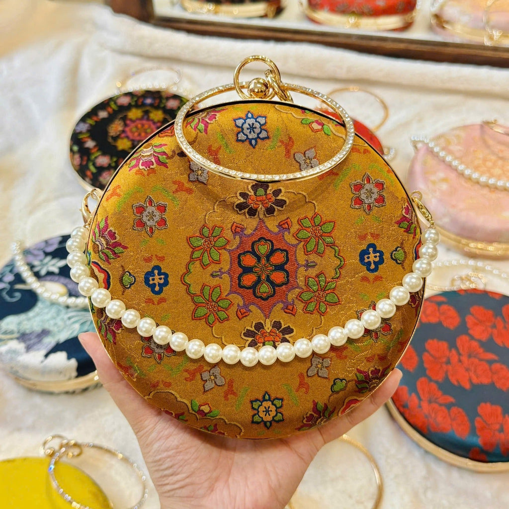 “Nguyệt Tú” – Printed Silk Round Clutch with Metal Handle in Yellow - front view | Vietnamese Luxury Fashion