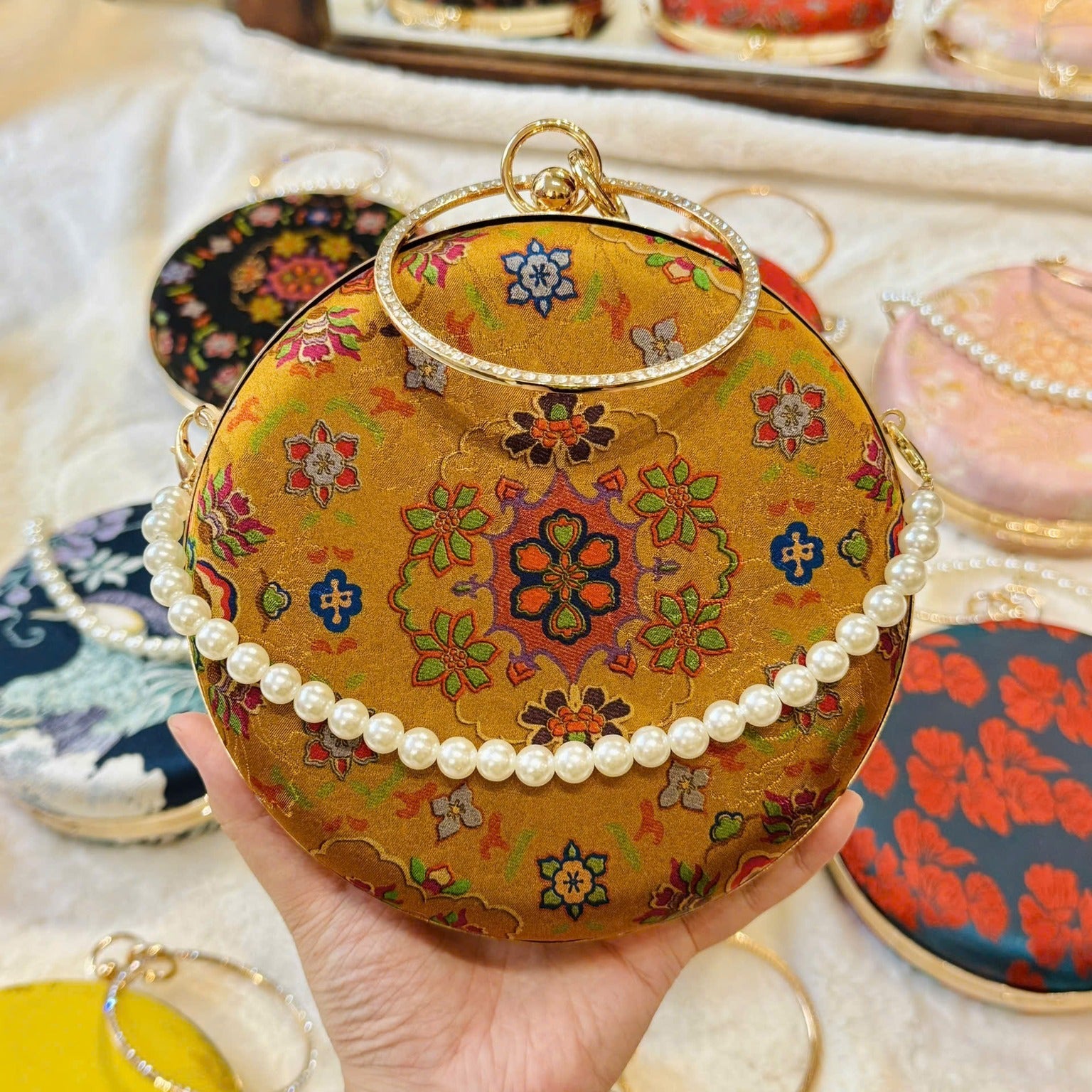 “Nguyệt Tú” – Printed Silk Round Clutch with Metal Handle in Yellow - front view | Vietnamese Luxury Fashion