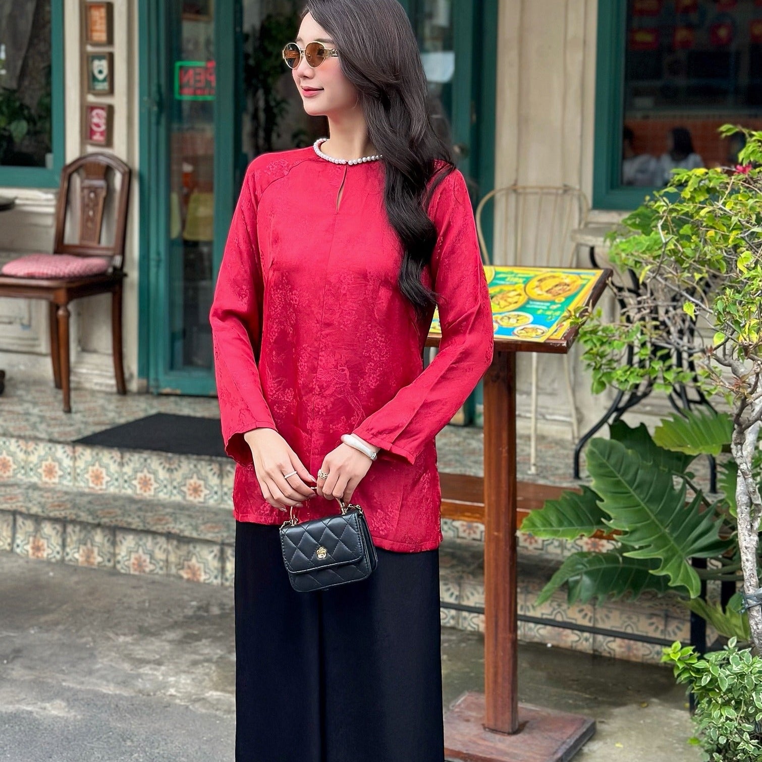 Side profile of Phuong Tien luxury áo bà ba showing pearl neckline embellishment and relaxed silk silhouette