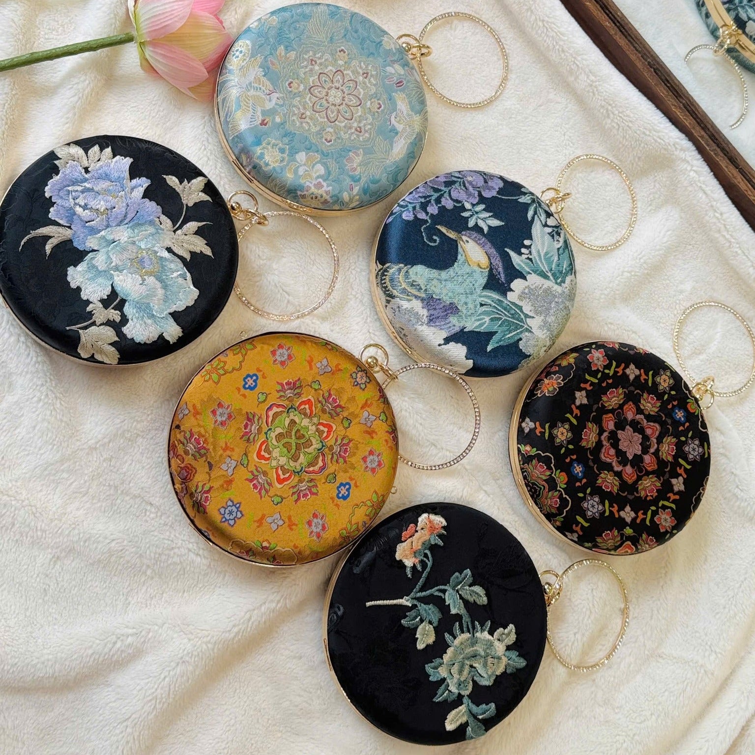 “Nguyệt Tú” – Printed Silk Round Clutch with Metal Handle in Yellow - lifestyle shot | Vietnamese Luxury Fashion