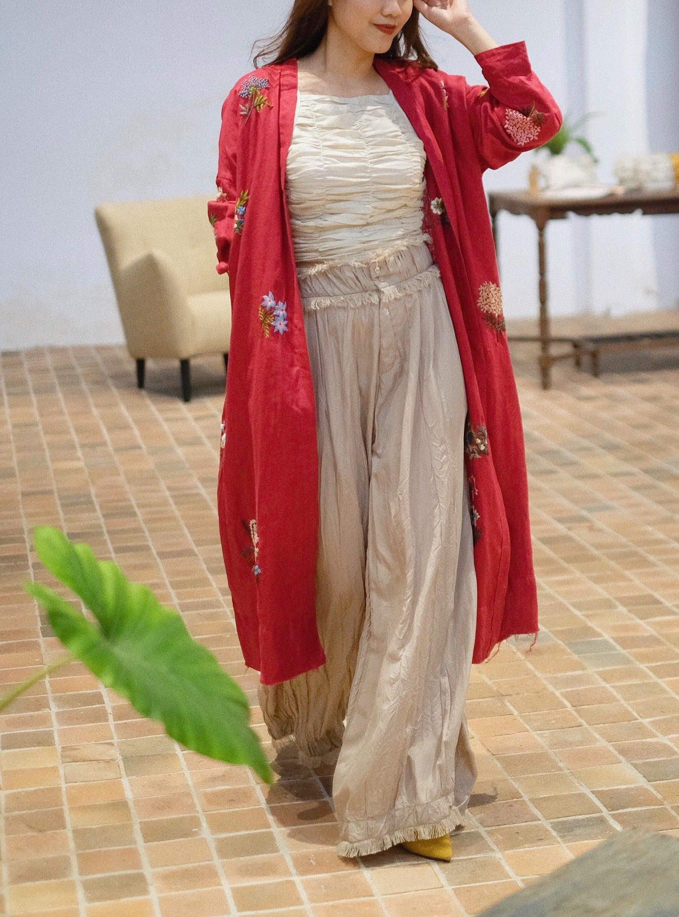 "Terra" embroidered linen cardigan by Huulala in red with floral artisan design, black accents, cultural authenticity.
