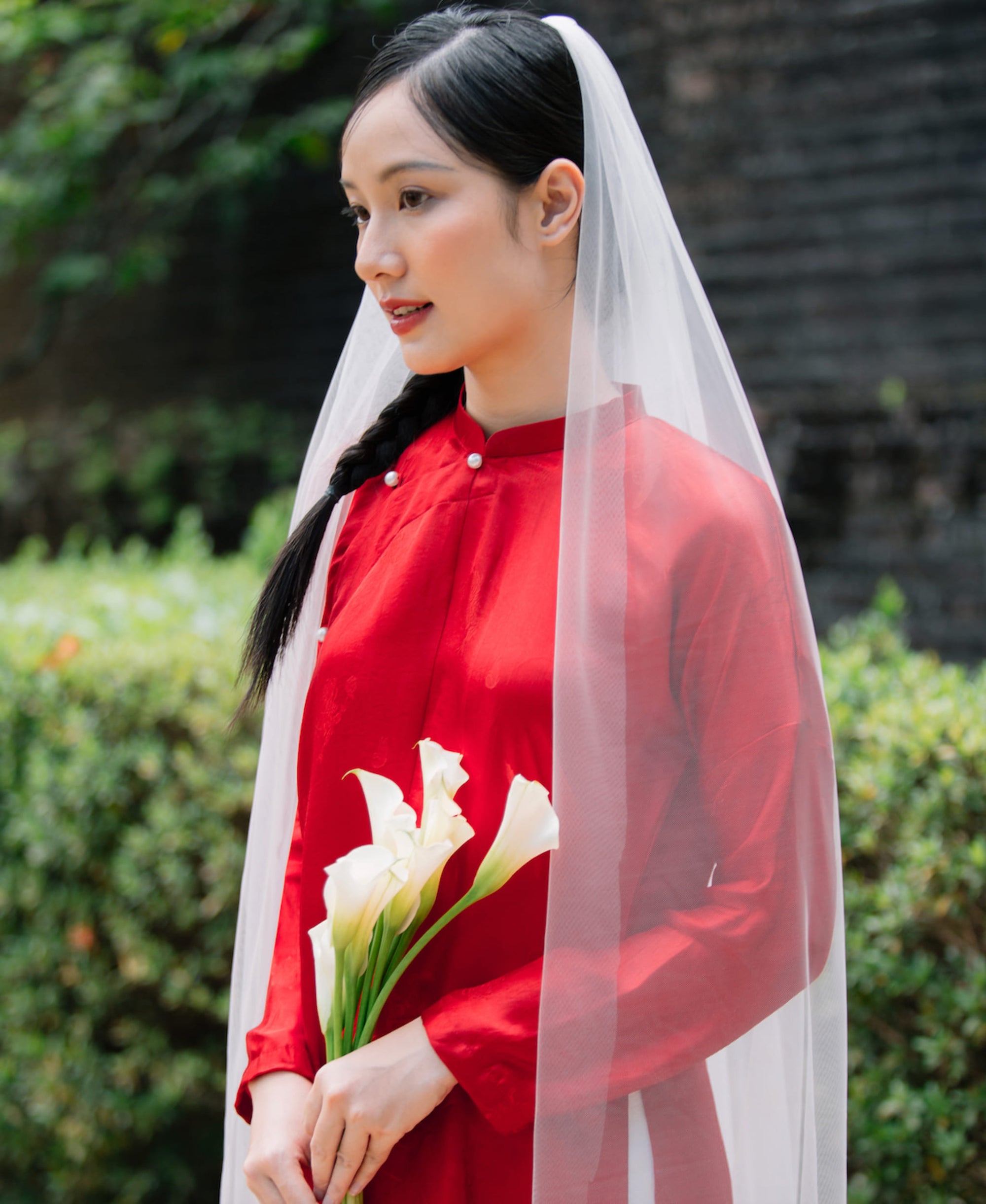 "Traditional Vietnamese 'Ngu Than' Ao Dai set in red silk by Moc, featuring artisan craftsmanship and cultural authenticity."